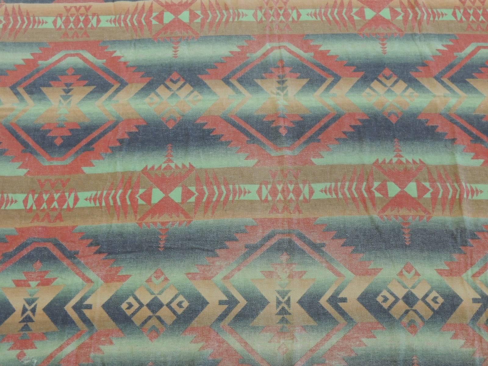 Vintage orange and green Southwestern design blanket with an eye-dazzler pattern.
Satin ribbon finish edges (some small repairs to ribbon.)

