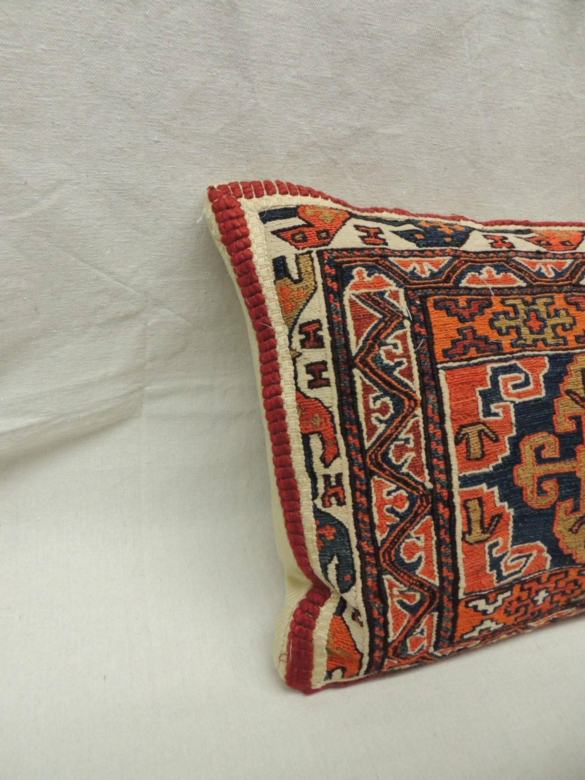 19th Century Uzbek Kilim large bolster pillow. Traditional tribal design in shades or orange, red, green, natural and blue. Framed with a linen and cotton red trim and natural linen backing.

