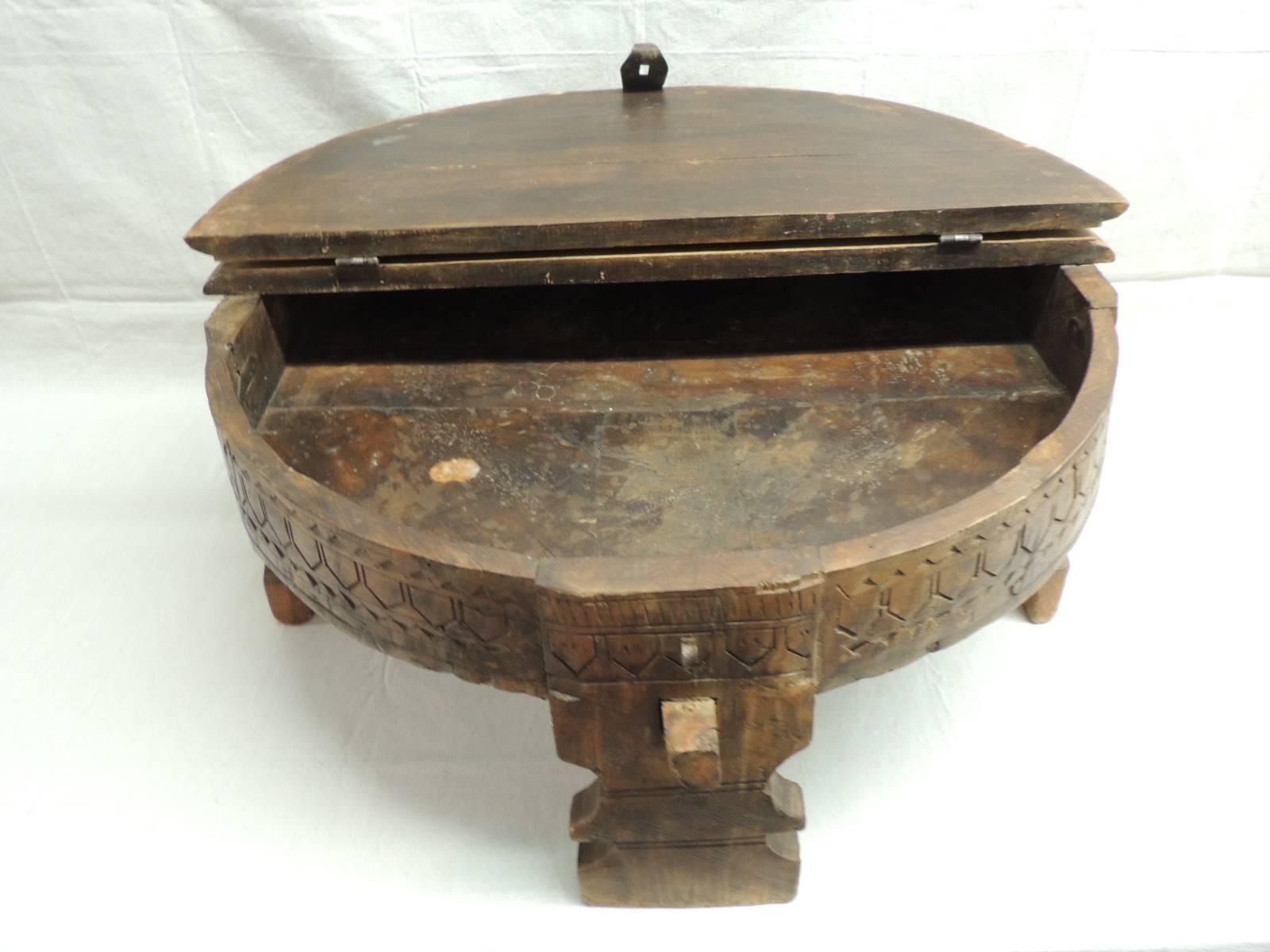 Moroccan wood carved coffee table with lid and original rusted hardware. Apron and legs are hand-carved.
27.5” D x 13” H.
     