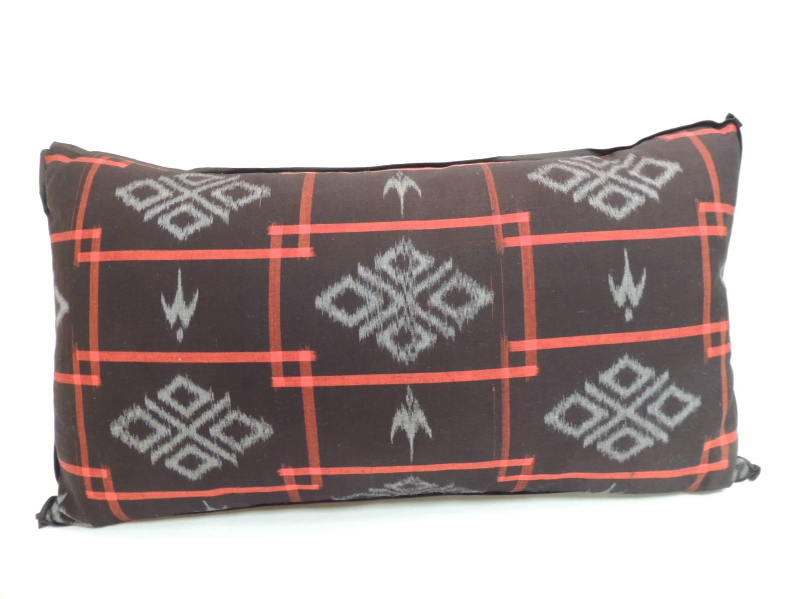 1960’s woven Red and Black Japanese Ikat graphic pattern bolster pillow with custom made black flat trim.  Decorative bolster pillow finished with a textured linen backing.  In shades of: black, red and blue.  Decorative bolster pillow handcrafted