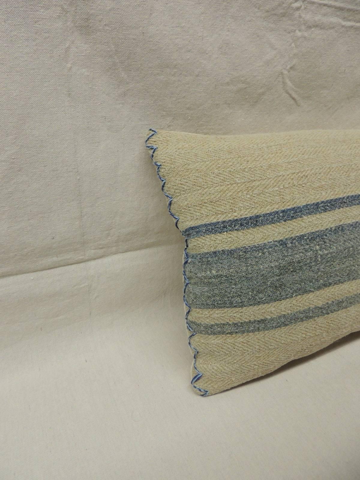 Late 19th century French linen home-spun bolster pillow with blue stripes and blue accent threads on each corner. The backing is in natural linen in shades of soft Wedgwood blue. Hand-crafted and designed in the USA with custom made pillow inserts