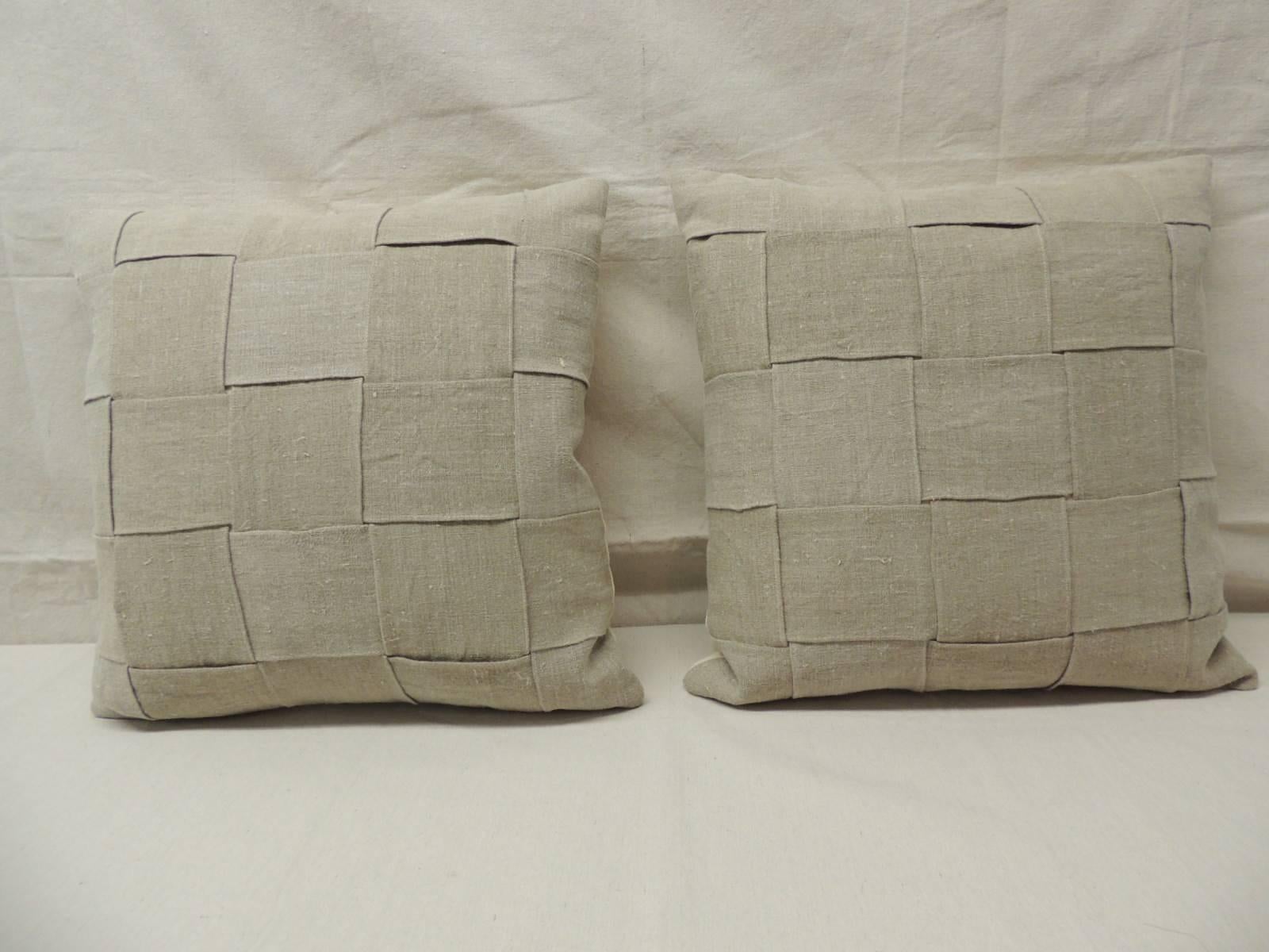 Pair of 19th century homespun French textured linen decorative pillows in oatmeal and natural.   
Exclusive Atelier Lam basket weave design. 19th century homespun decorative French pillows finished with natural linen in the backings.  Homespun