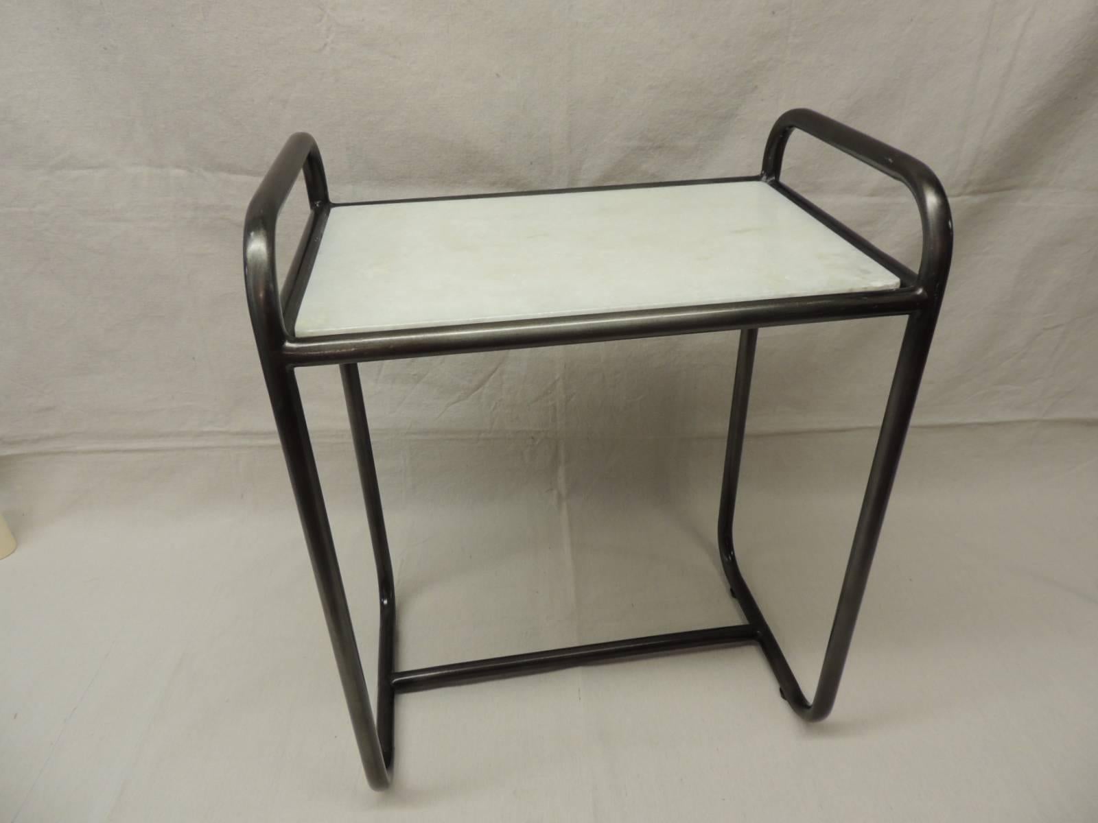 Offered by the Antique Textiles Galleries:
Vintage tubular Industrial side table.
Machine Age side table.
Gun metal finish with a white marble inset top.Size: 18” W x 12” D x 23.5” H x 20.5” to marble top.
                       