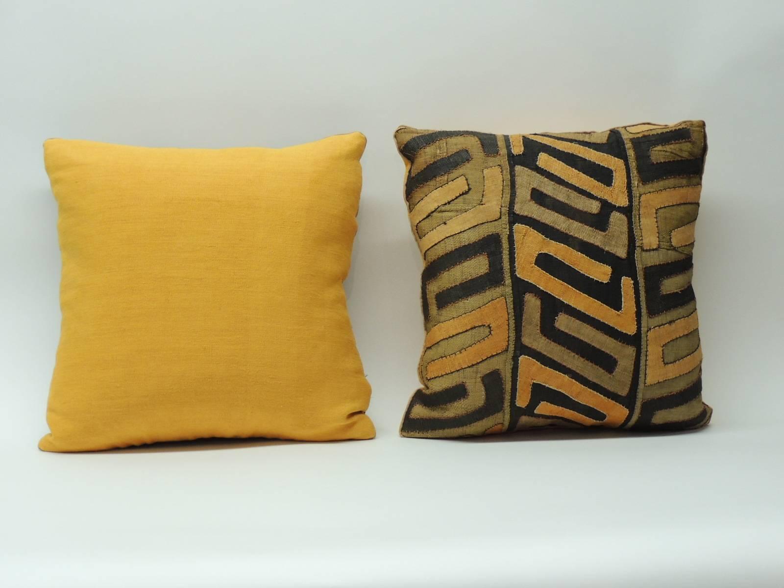 Pair of 19th century African Kuba pillows.  Tribal design orange and black appliqué on raffia decorative pillows. Textured orange backings with a small cotton trim all around.  Hand-crafted and designed in the USA.  Custom made pillow insert. 