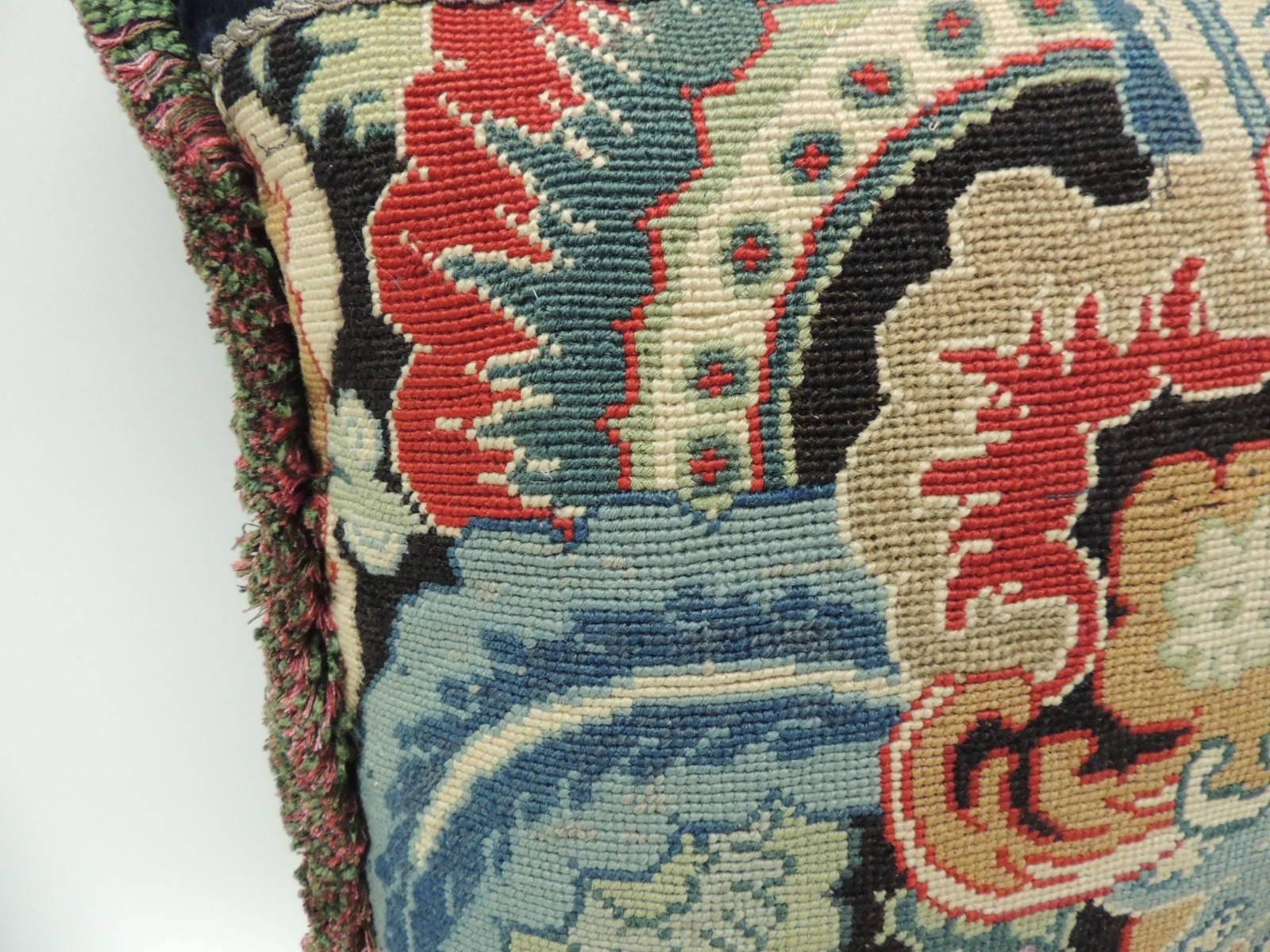 French needlework tapestry decorative multi-color pillow hand-stitched with an 18th century fragment that depicts a floral pattern. The color palette in the front panel depicts shades of mustard, yellow, green, orange, glue and garnet red on a