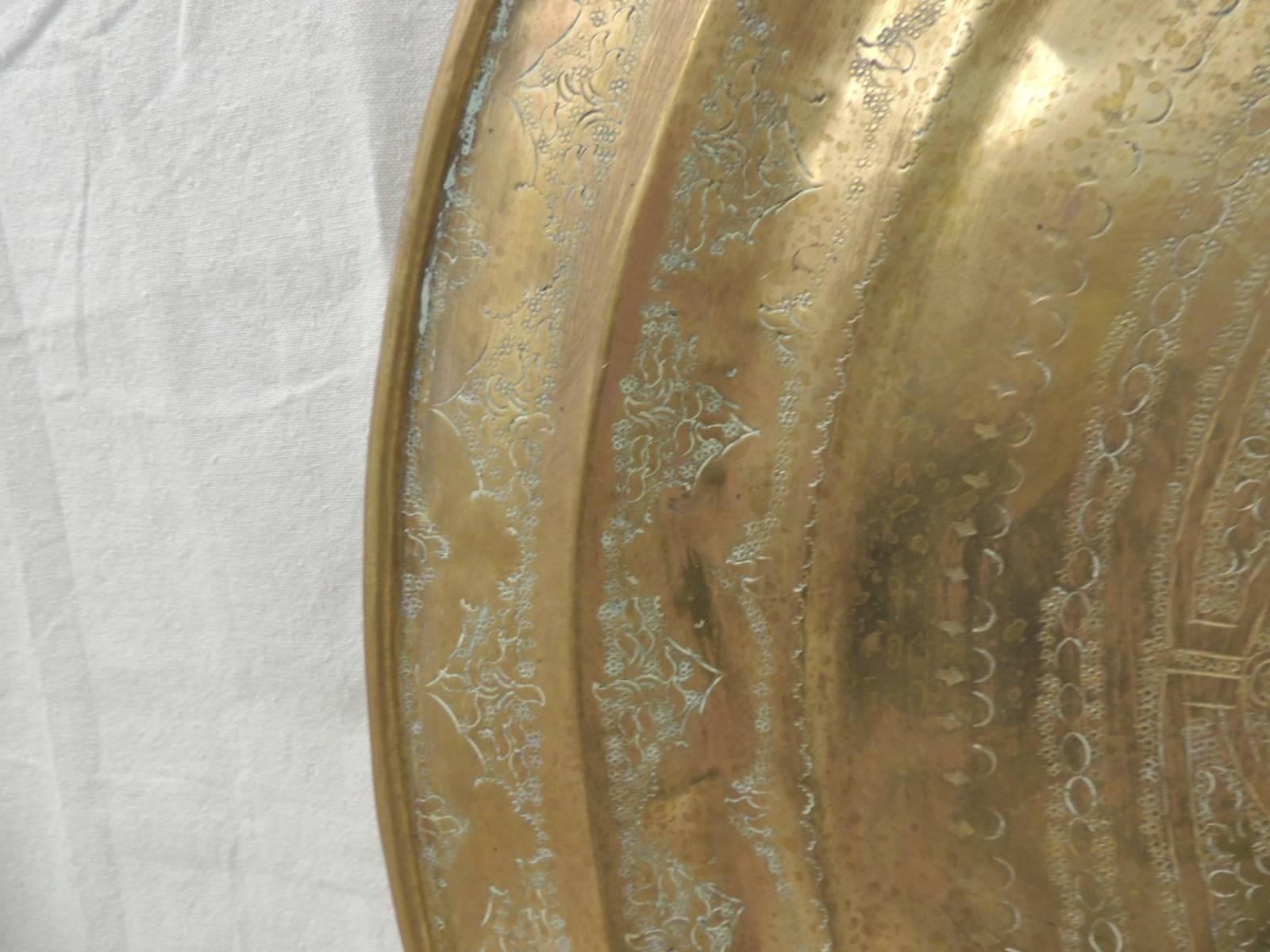 Large brass Persian round vintage tray.
Large brass Persian round vintage tray with hand-forged edges and star in the center. Hammering details includes flowers and trees all around the center star. Excellent patina due to aging. No hanging hook in