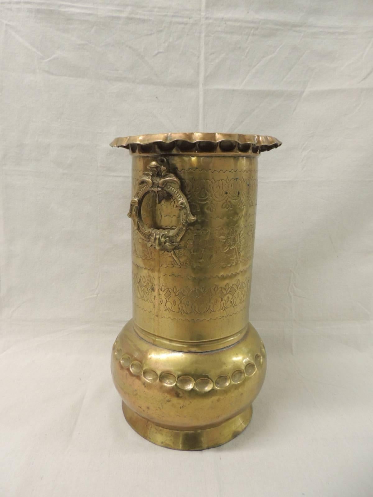Monumental vintage Persian brass vase.
Monumental vintage Persian vase with hand-hammered brass throughout the piece with two (2) beautiful ornate carved brass handles and a thumb print on the lip at the top. Ideal for tabletop flowers or as an