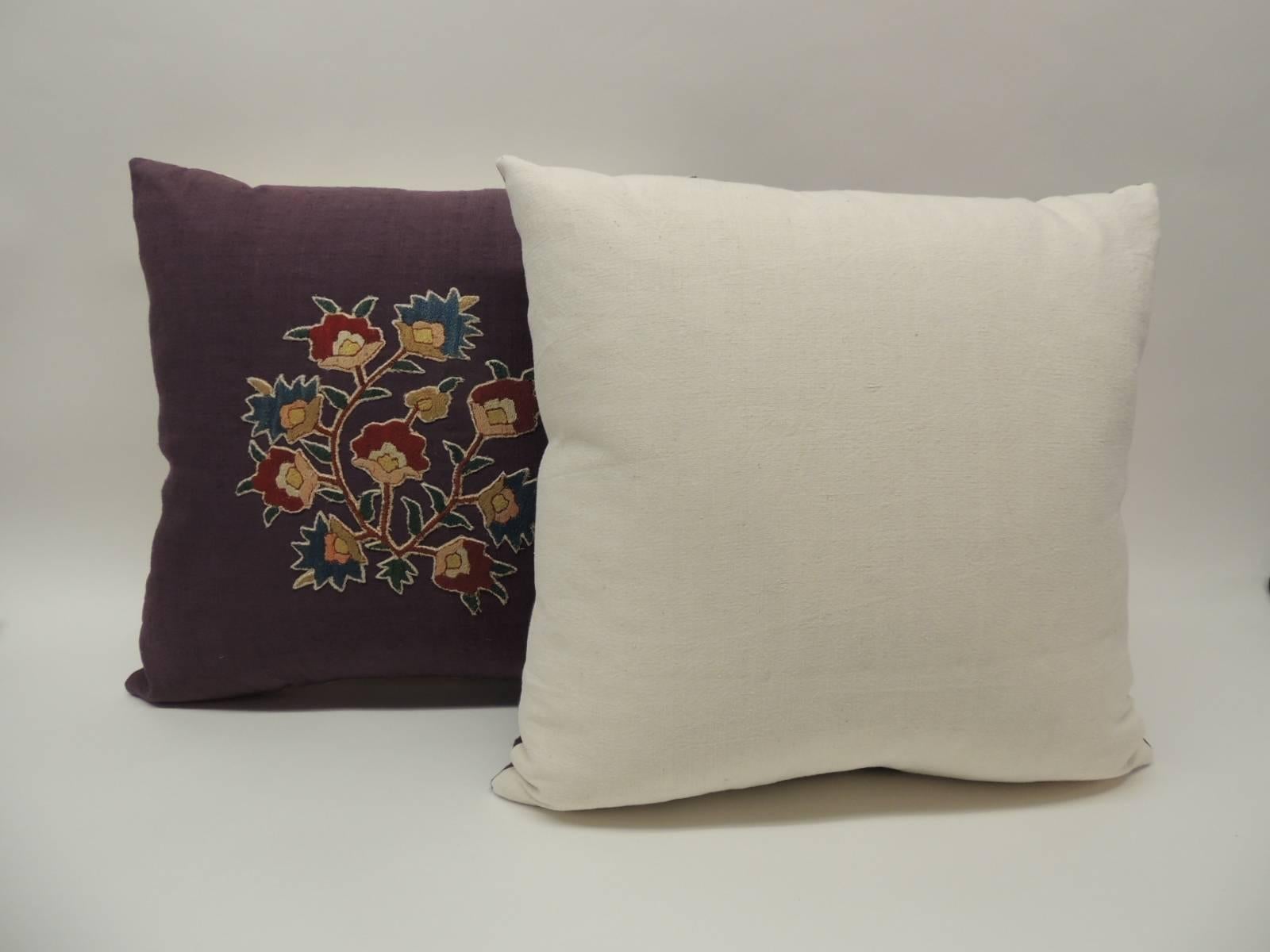 Pair of 19th century Turkish embroidery hand appliqué on purple home-spun linen decorative pillows depicting a floral motif. The hand-embroidery appliqué in shades of red, yellow, gold, blue and natural shades. The backing of these decorative