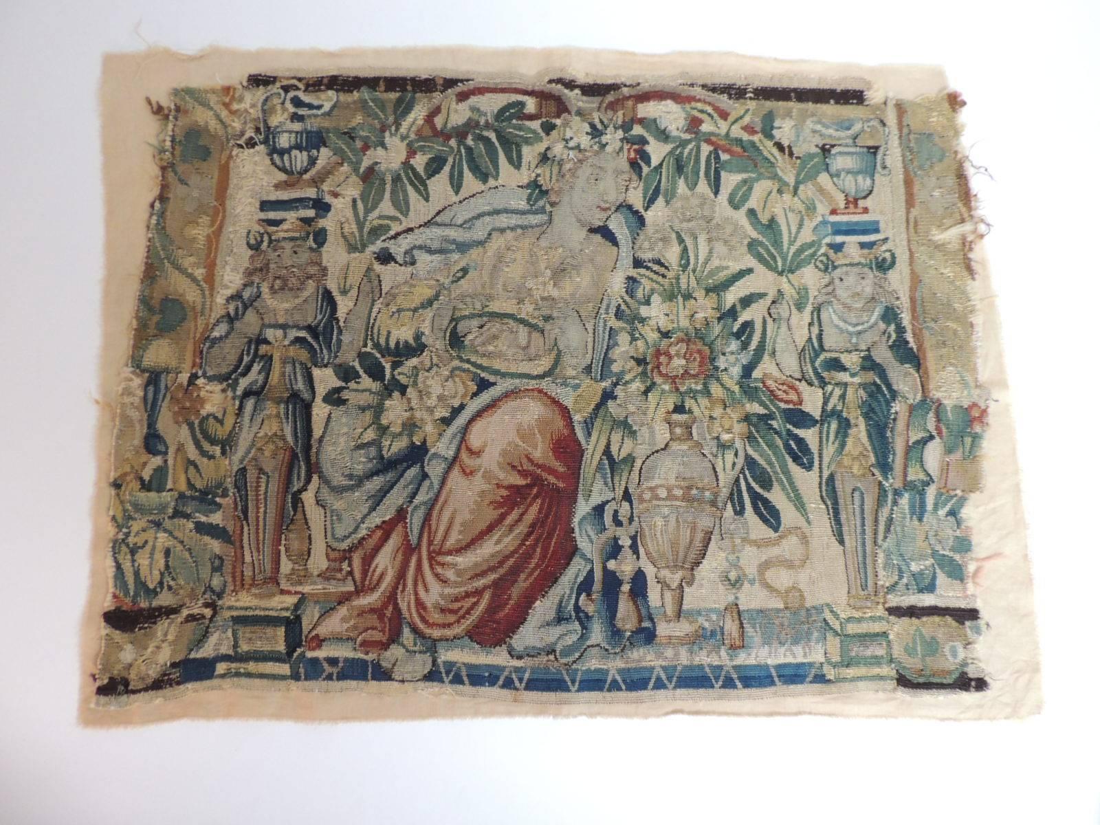 From: Antique Textiles Galleries
Aubusson tapestry panel depicting scene of a Goddess holding court. Framed by carved colorful statues of men and a women in regal clothing. The overall flora around it is bright color branches and flowers in bloom.