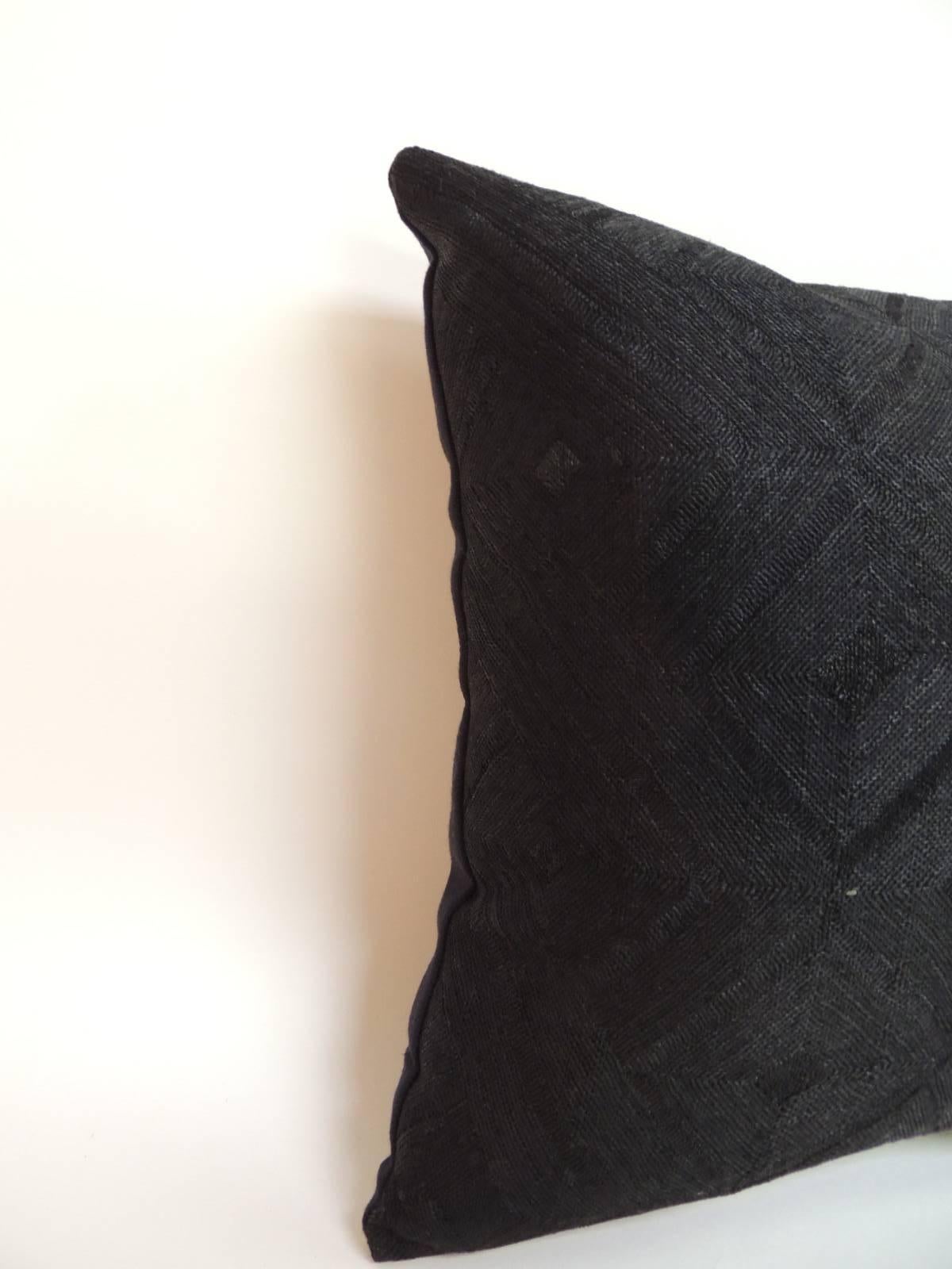 Unusual black dyed hand woven raffia decorative pillow with black textured linen backing. Decorative pillow designed and handcrafted in the USA. Hand-stitched closure (no zipper.) custom-made pillow insert. The word Kuba means lighting referring to