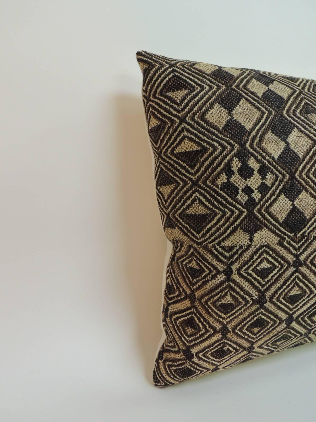 Tribal woven and embroidery African decorative lumbar pillow. Over all square woven design in straw cloth/raffia to create this unique design. In shades of tan, camel and light brown. Natural linen backing. Decorative pillow designed and handcrafted