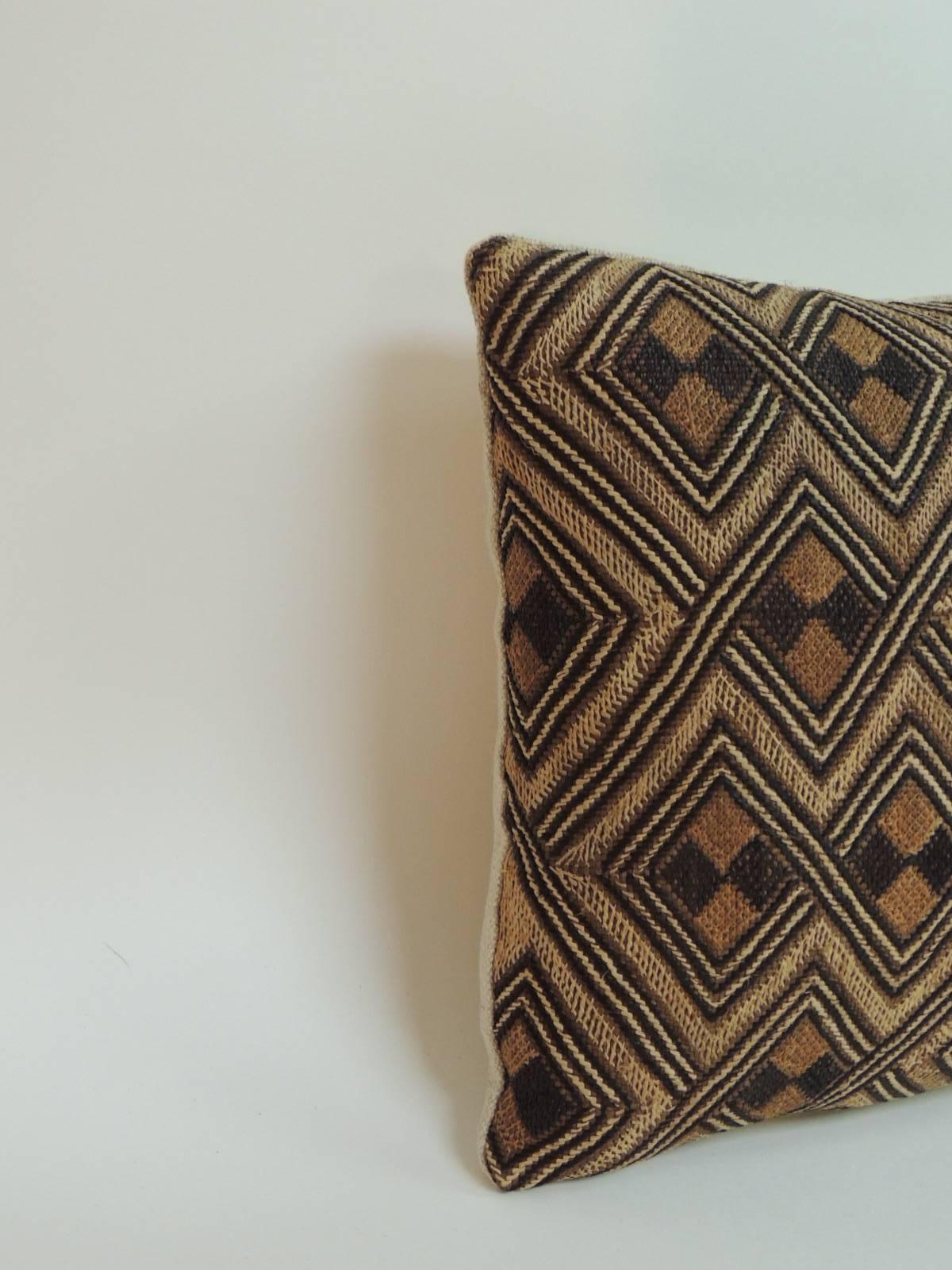 Offered by the Antique Textiles Galleries:
Tribal woven and embroidery African artisanal textile lumbar pillow. Tribal graphic diamond pattern straw cloth/raffia woven textile in shades of brown, camel and tan with homespun textured linen.