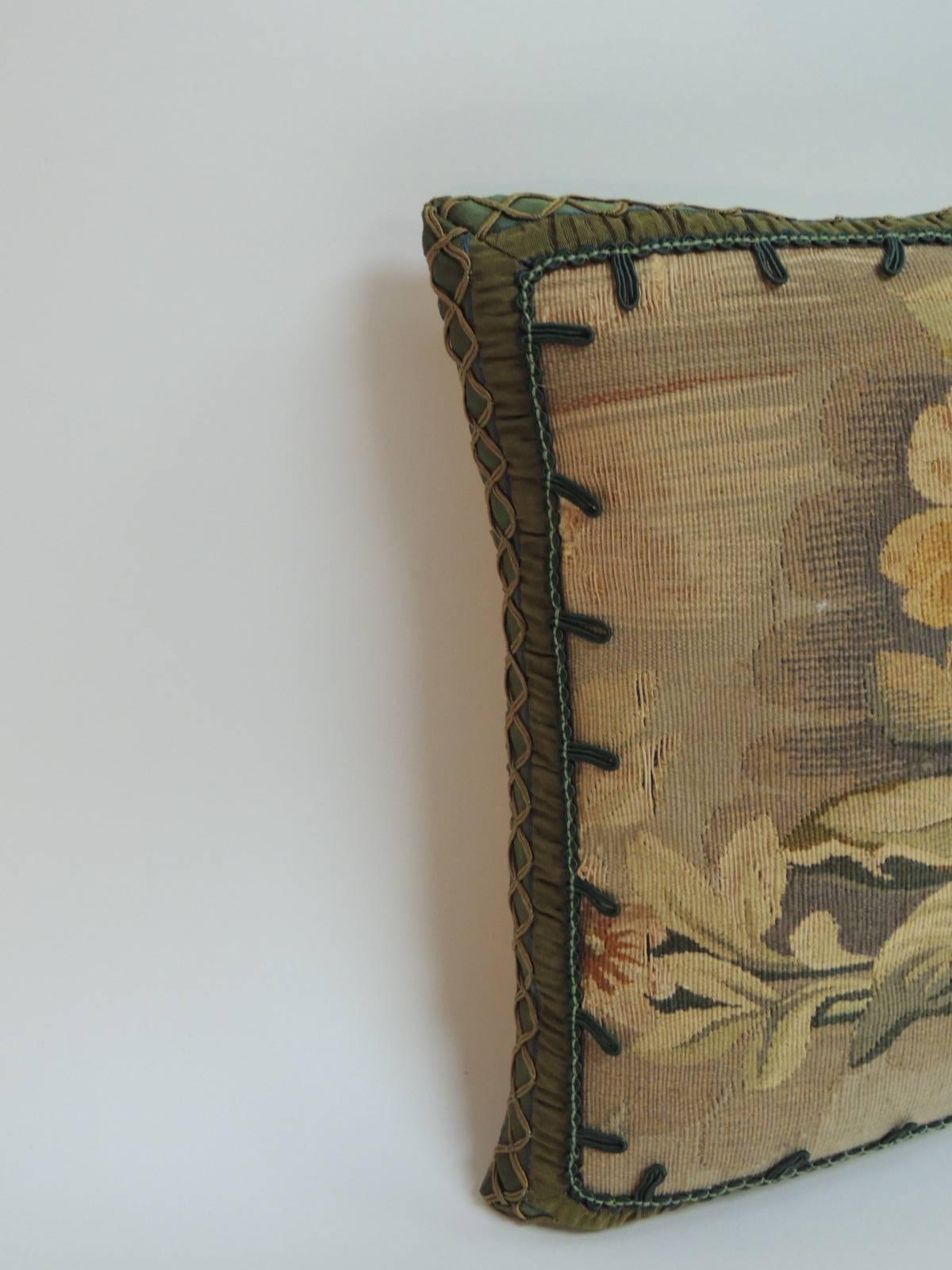 Petite floral Aubusson decorative petite pillow with silk braided trim all around and small hunter green hand-knotted silk decorative trim frames the floral design on the front of the small pillow and tan silk backing. A centuries-old tradition, the