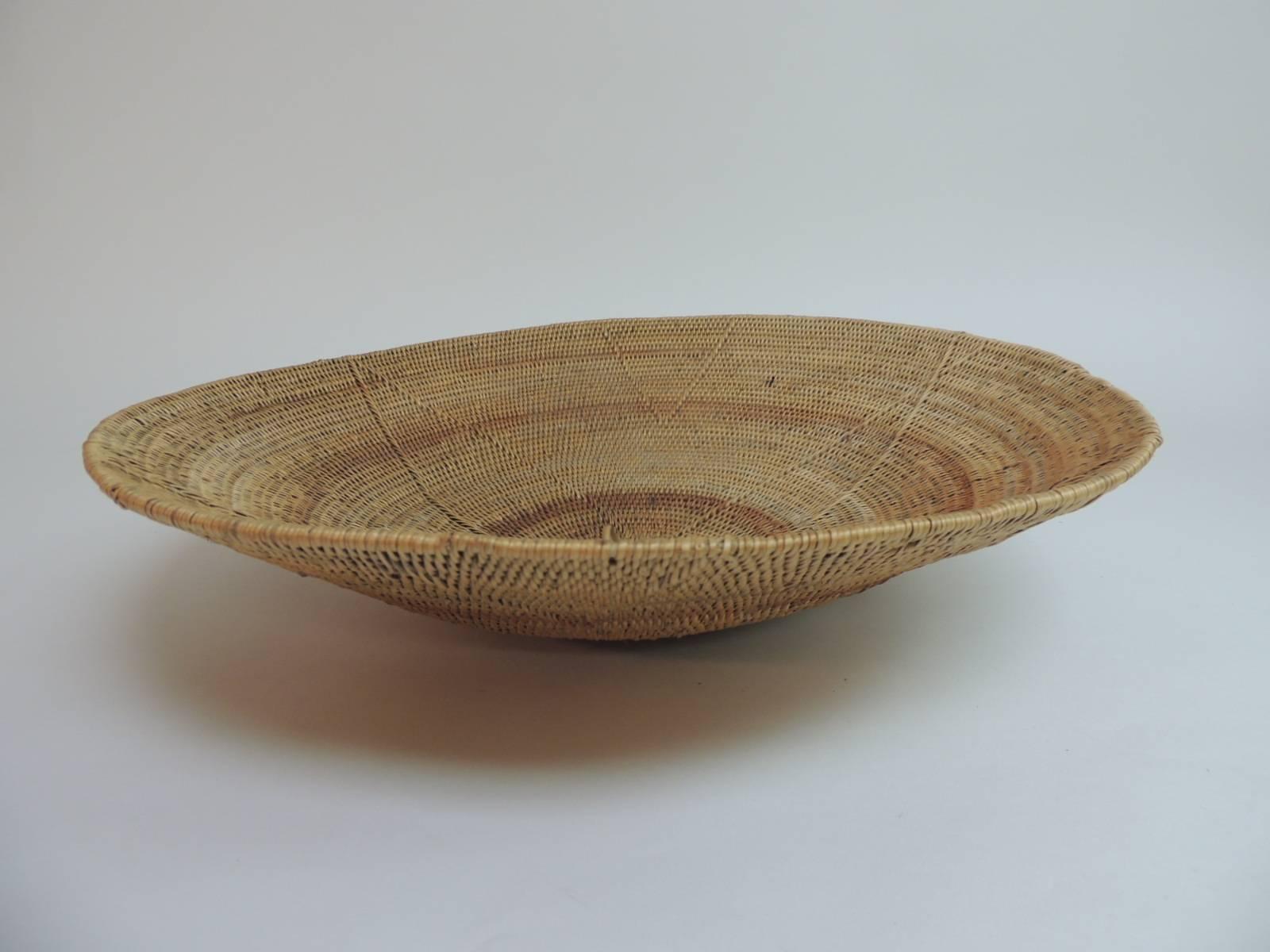 Offered by the Antique Textiles Galleries:
Round vintage seagrass tribal woven African artisanal basket. Not flat-shaped like a bowl.
Swirl intricate design and weave.