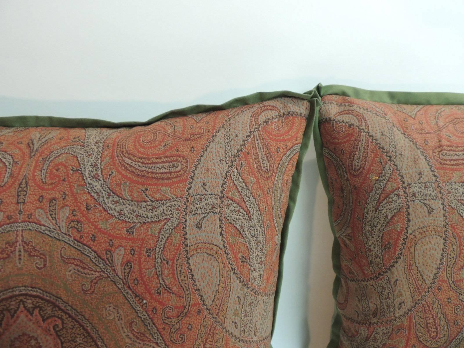 Pair of 19th century, Kashmir woven paisley decorative pillows
Pair of antique textiles paisley decorative pillows with ATG sheer cotton green flat trim and textured linen green backing. Antique textile fragments in the front are with shades of,
