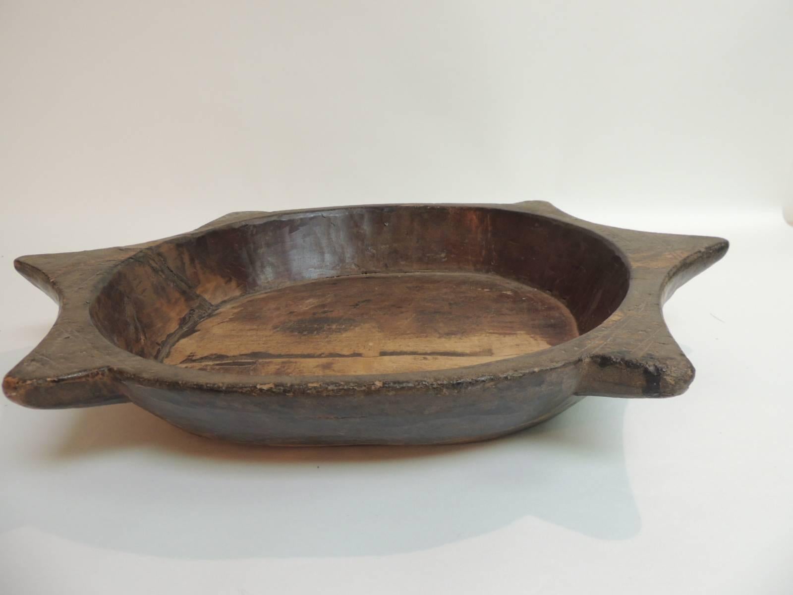 Offered by the Antique Textiles Galleries:
African hand-carved wood bowl.
Wood used to handcraft these rustic African bowls can vary and sometimes we get them in carved out of Kiaat wood and is found throughout the South of the African continent.