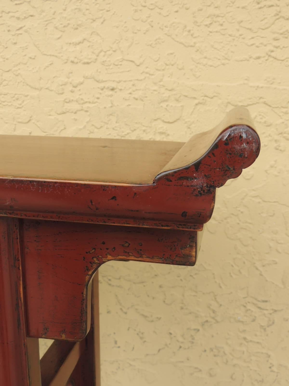 Offered by the Antique Textiles Galleries:

Vintage Chinese red cinnabar lacquer altar table vintage Chinese red lacquer altar table with black under tones under the red lacquer. Pierce side panels with rectangular feet and square side panels under