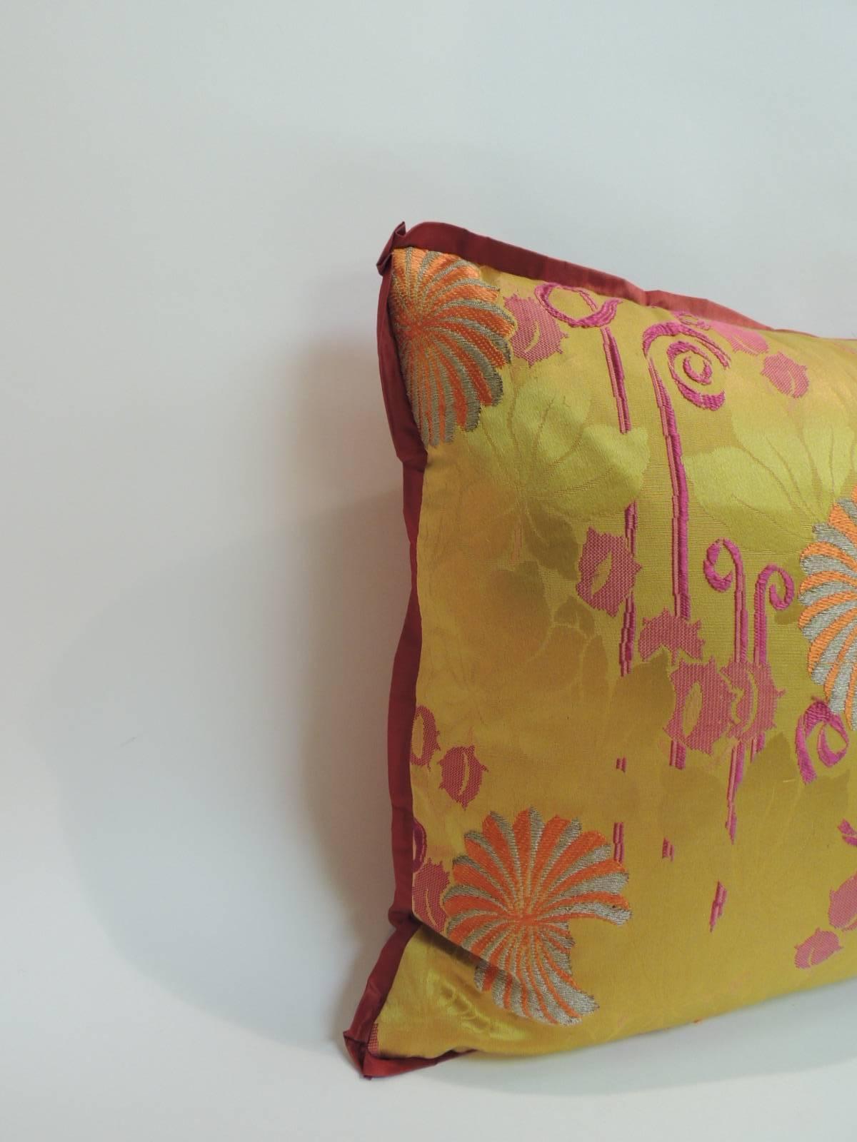 19th century Japanese bolster pillow with an embroidered textiles panel, metallic threads on silk. The floral pattern on the panel of the accent pillow is in shades of orange, silver and purple on a damask gold background with custom red silk flat