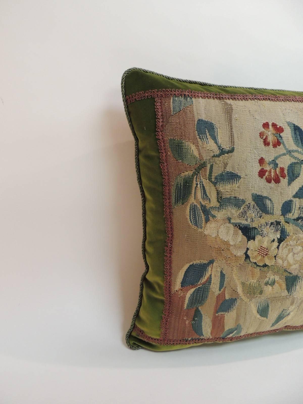 18th century decorative Aubusson tapestry pillow depicting a man framed with hunter green silk velvet, antique copper color metallic trim all around and rope trim at seams. In shades of green, copper, yellow, blue, red, orange and gold. Green silk