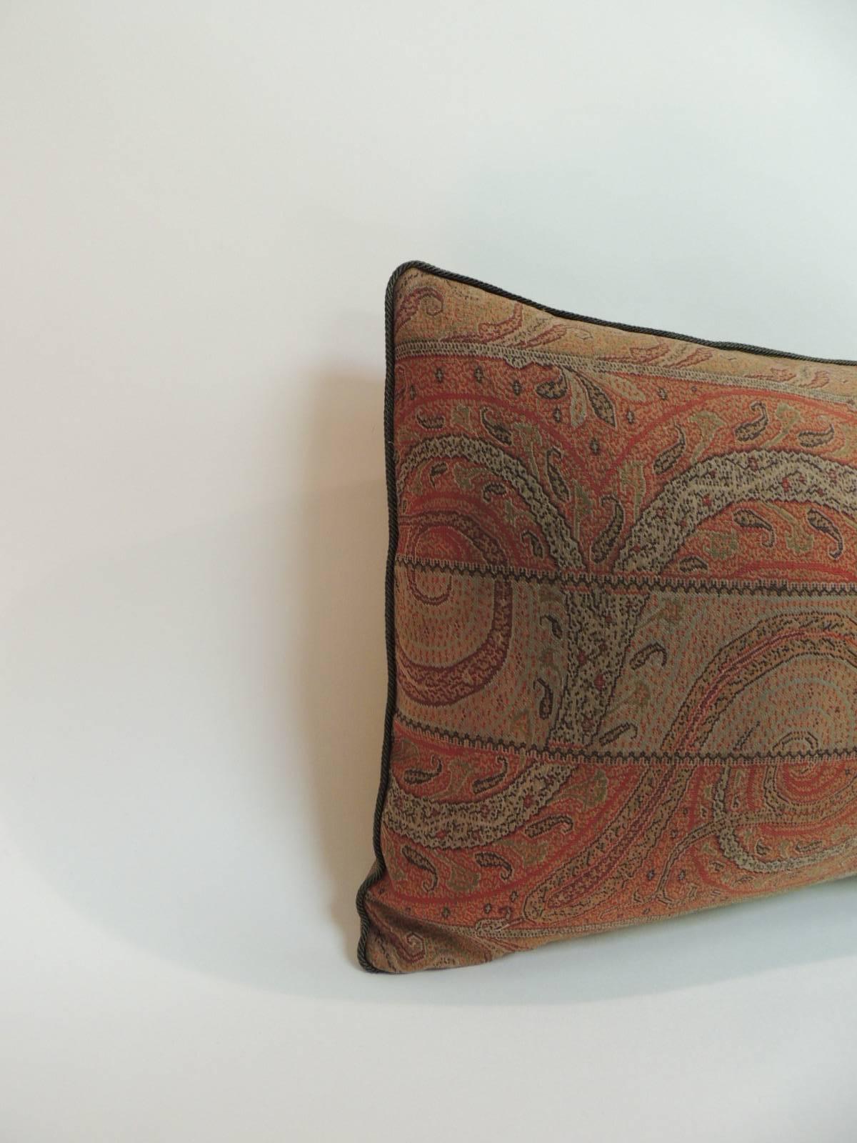 Antique wool paisley bolster pillow, embellished with small green rope trim all around and textured brown backing. In shades of green, red, brown, orange, brown, black and yellow.
Needle embroidery. handcrafted decorative pillow made with a textile