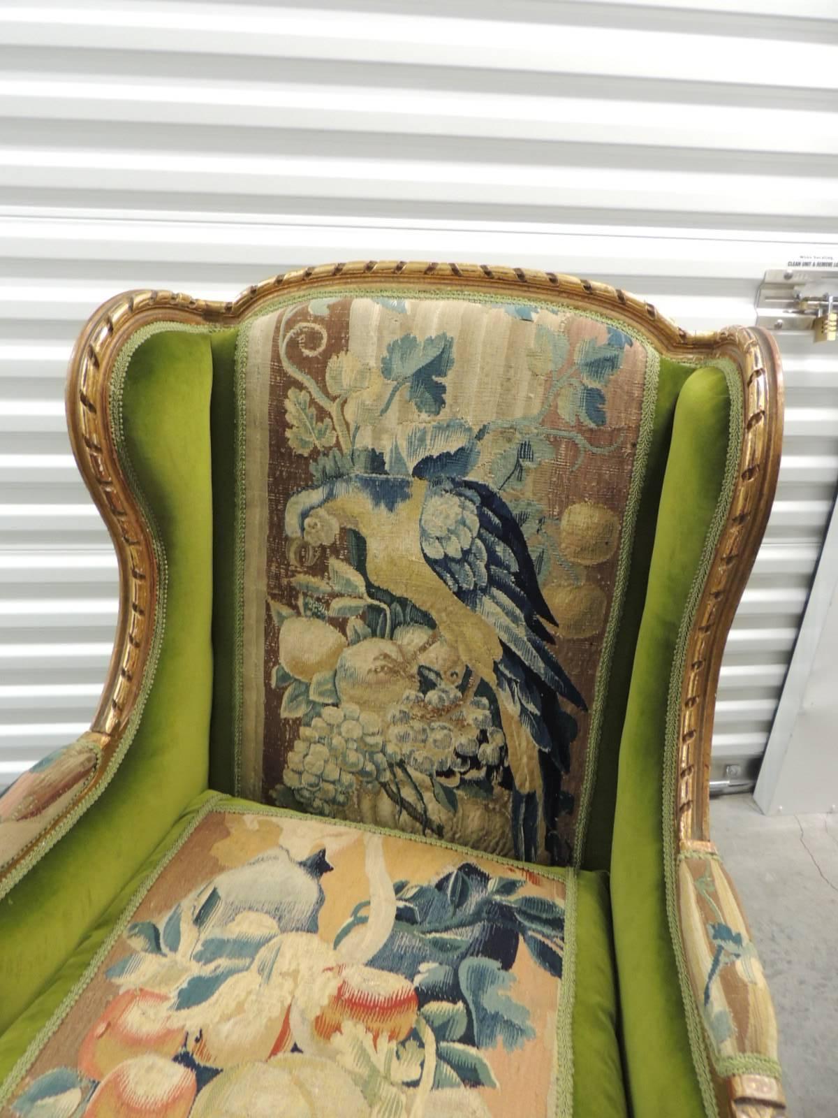 Antique Textiles Galleries:
Wing French/Bergere chair re-upholstered with and 18th century Aubusson tapestry with hand-carved and gold leaf details. Back panel of the wing chair is an Aubusson tapestry depicting a winged cherub holding a garland and