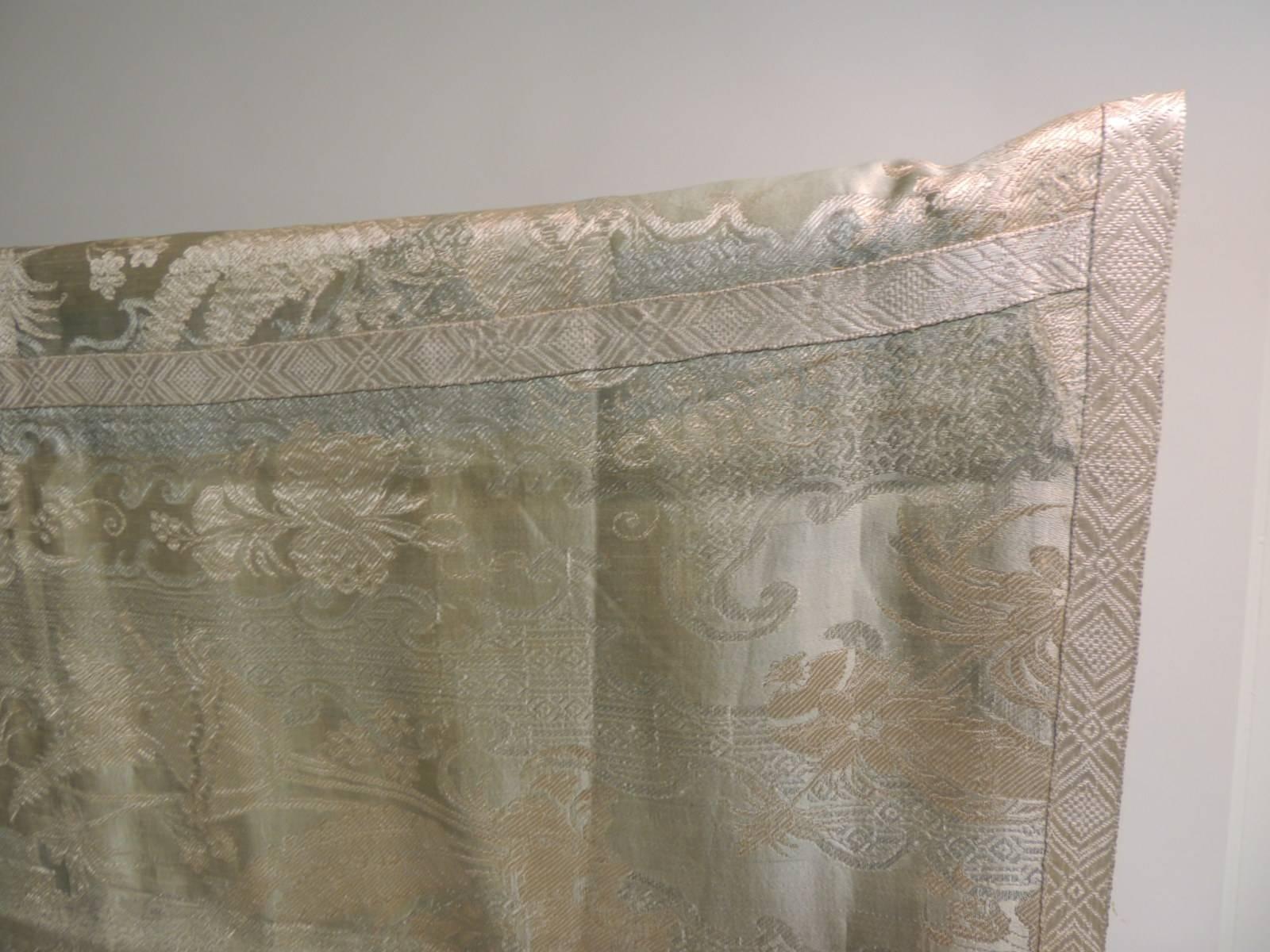Celadon green and grey with some faded tone-on-tone flowers framed with silver metallic trim and across the center of the cloth. Lined with yellow solid silk backing.
(one small pink stained from aged)
Ideal for a dining table, center table, could