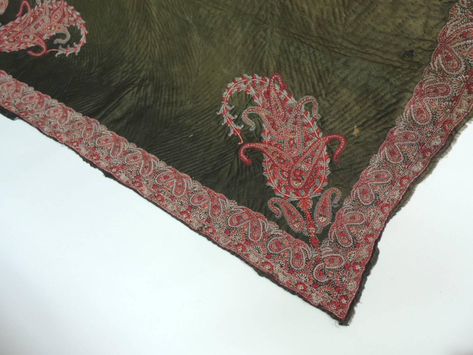 Antique Textiles Galleries:
18th century hunter green quilted center, creating a chevron pattern and embellished with an intricate red floral border and paisleys on all  four corners. The back has original sari silk print.
Note some fading due to