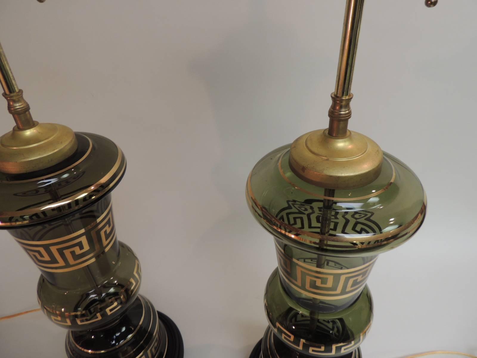 Pair of 1920's hand blown glass tall lamps with hand-painted gold Greek key 
Newly rewired and mounted with round wood bases and polished brass fittings. On and off switch on the sockets and in the plowing wire. Finials are included.
Note: There is