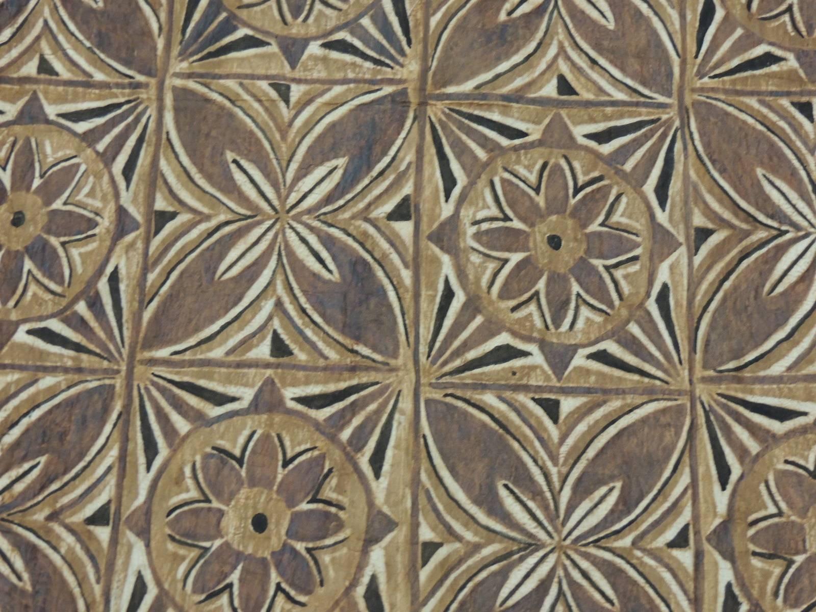 Tapa Decorative Artisanal Brown and Orange Paper Art
Tapa paper is made with the bark cloth panels with a floral design on geometric squares.  
Tapa decorative paper in shades of brown, natural and orange embellish the art.
Size:  46” x 51” 
