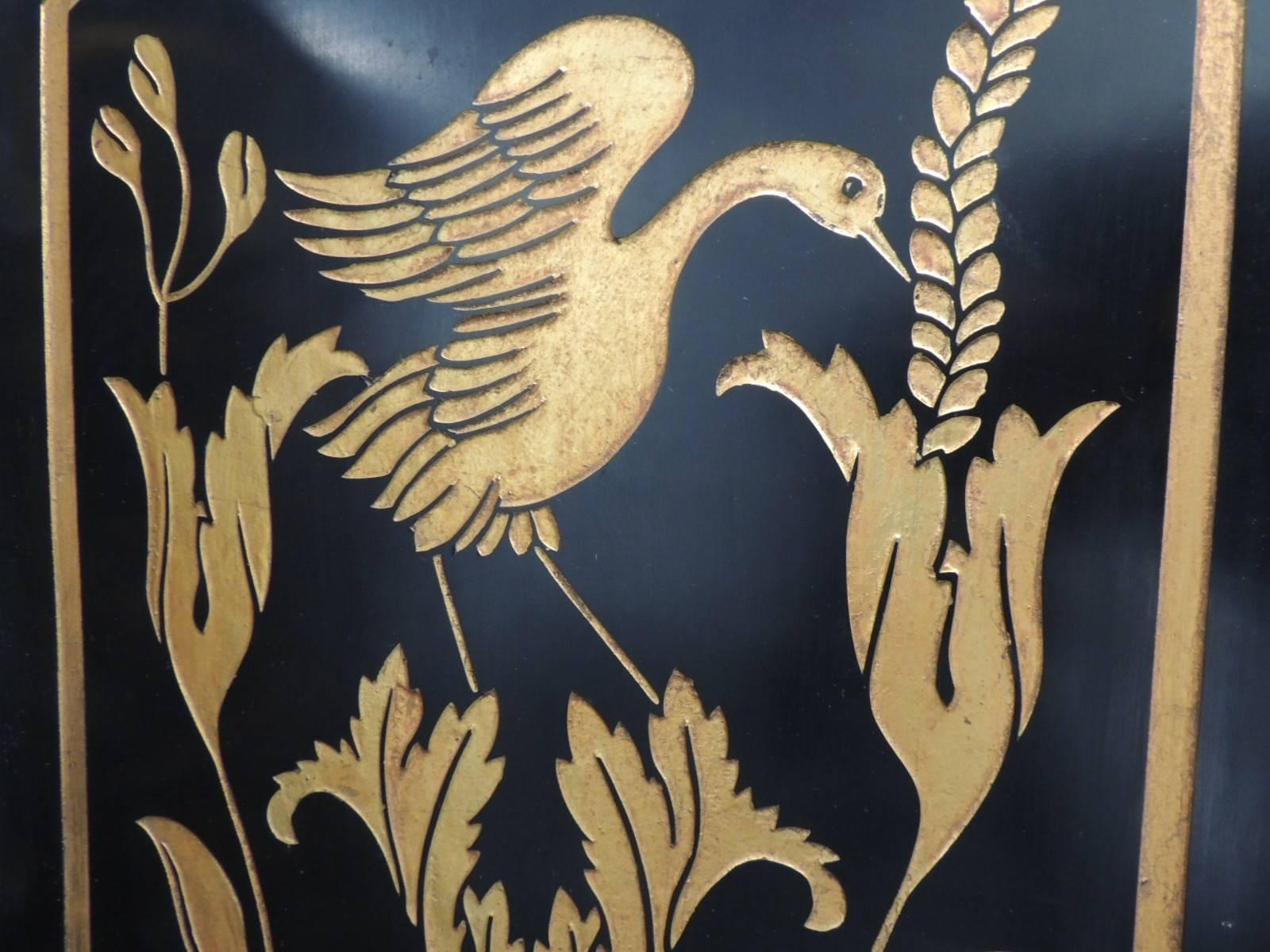 Modern black and gold lacquered folding screens with birds
Folding screens in black and gold depicting flowers and birds with small brass feet and brass hinges. Rectangular panels with rounded tops and gold leaf onto black lacquered wood.
Back of