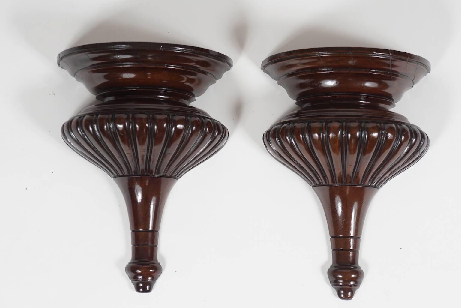 Pair of carved, fluted mahogany wall brackets.