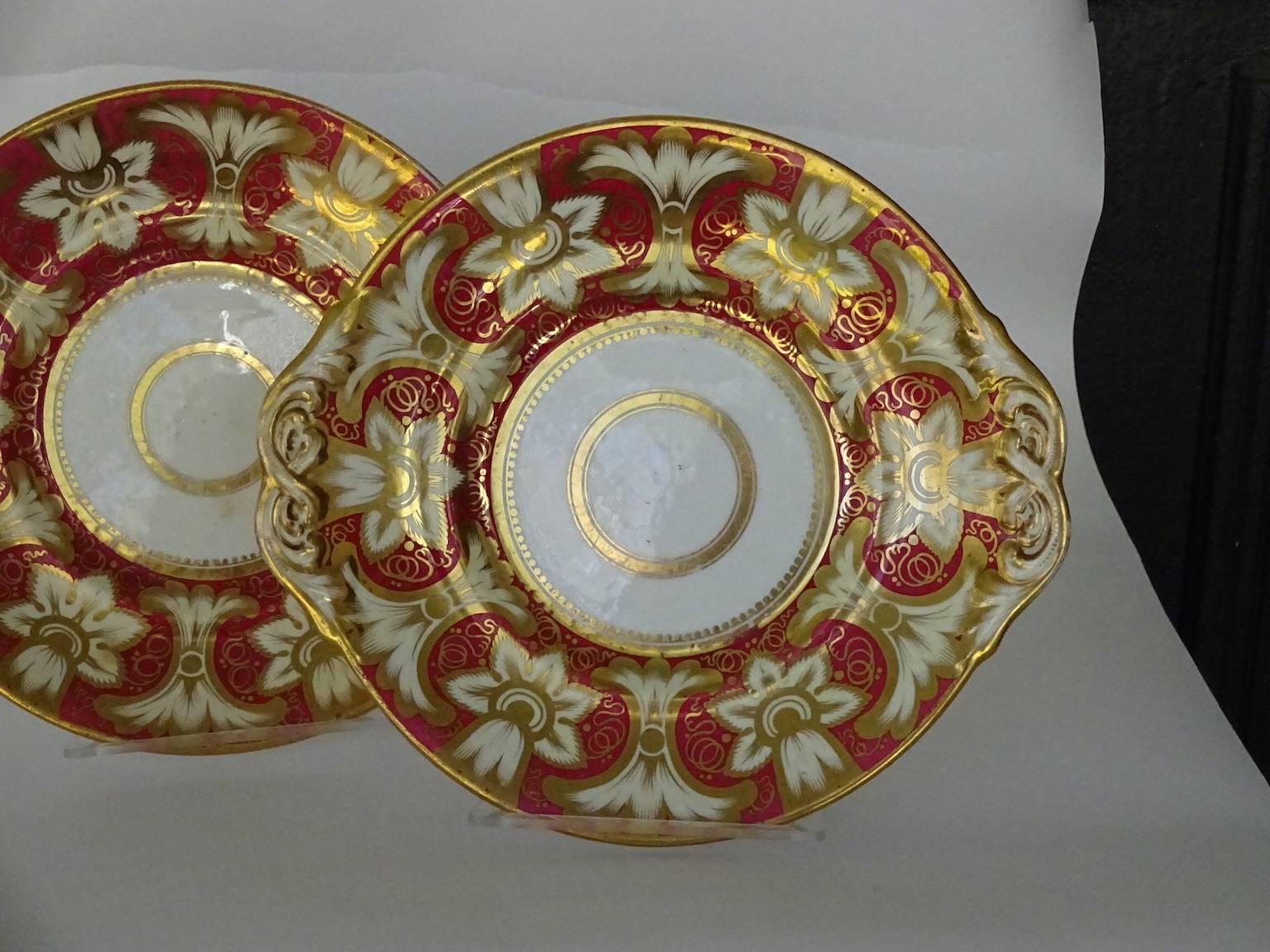 Pair of red and gold Victorian plates, on white ground. Flowers and flourishes.
Ovoid shape. Probably dessert plates, but lovely decorative plates for any table. No maker's mark but probably English and circa 1850.
