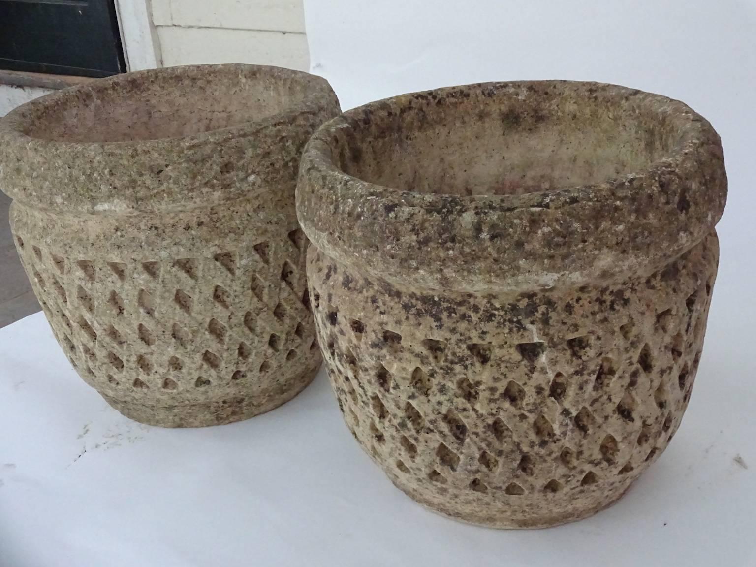 Handsome pair of English cast stone planters or urns with attractive honeycomb pattern, circa 1950. Lovely patina.