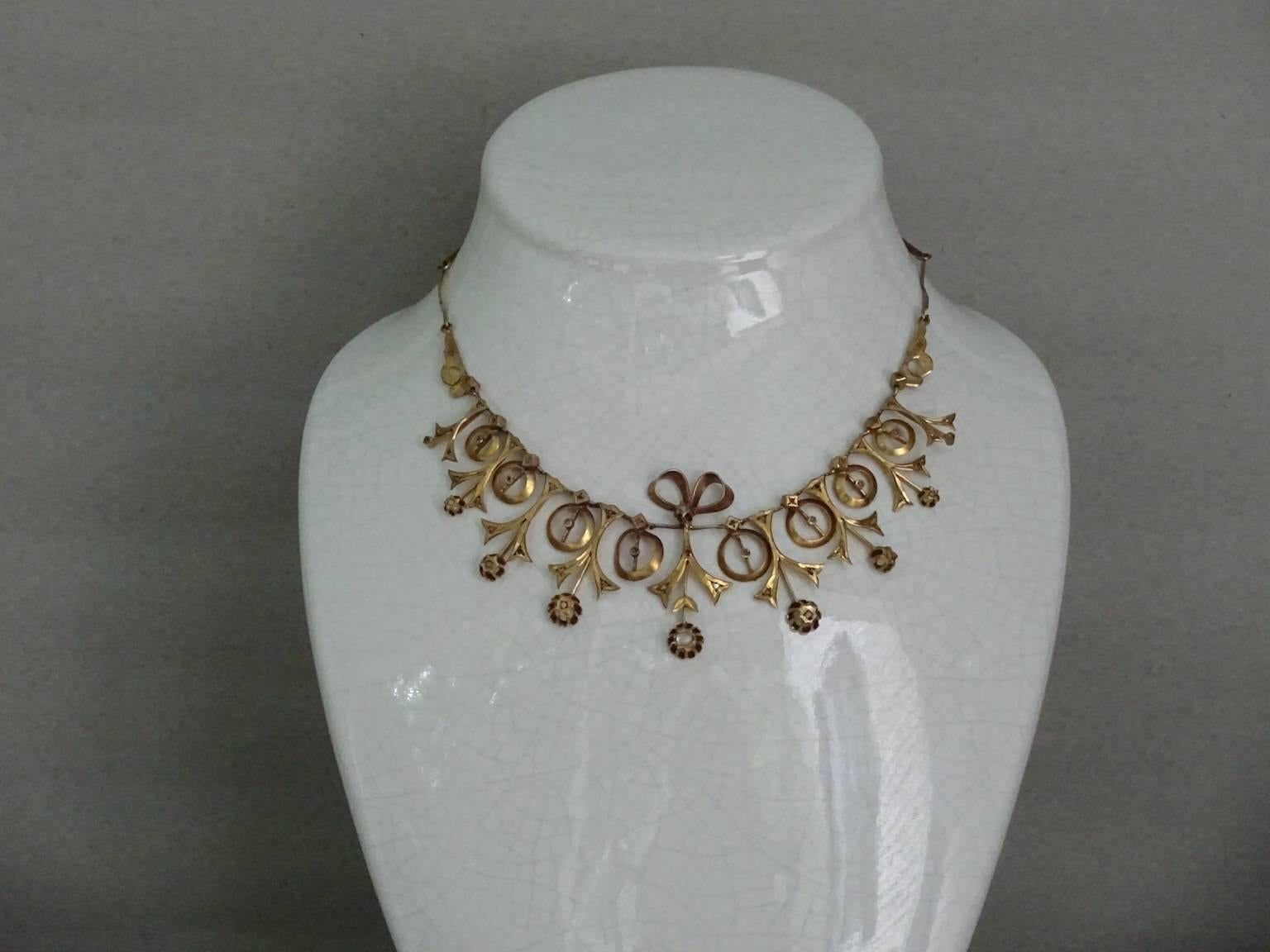 Delicately wrought gold washed brass necklace with paste diamonds,
fastens with a hook to the side of the neck.