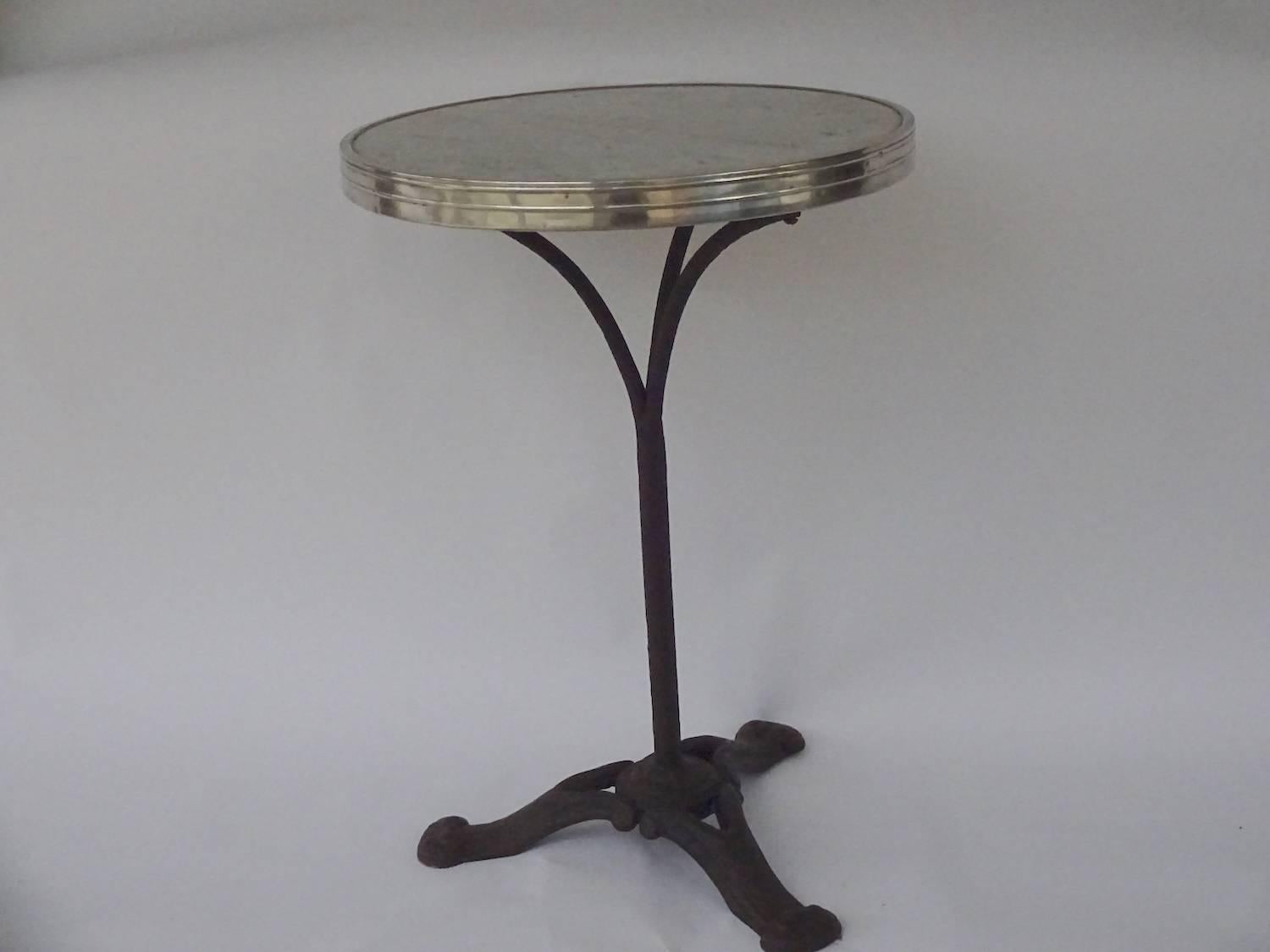 Charming French gilt-metal mounted marble and cast-iron cafe or bistro table.