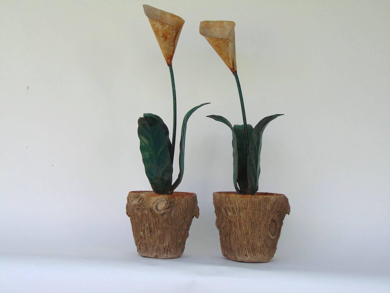 Stunning very similar pair of decorative tole peinte calla lilies in concrete faux bois jardinières,
one slightly taller than the other. Very realistic treatment of wood on the pots. The smaller of the two is 29.5
