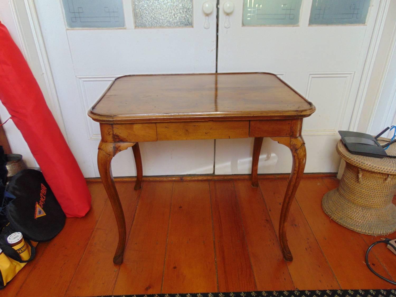 Italian Rococo Provincial walnut single-drawer table, cabriolet legs.