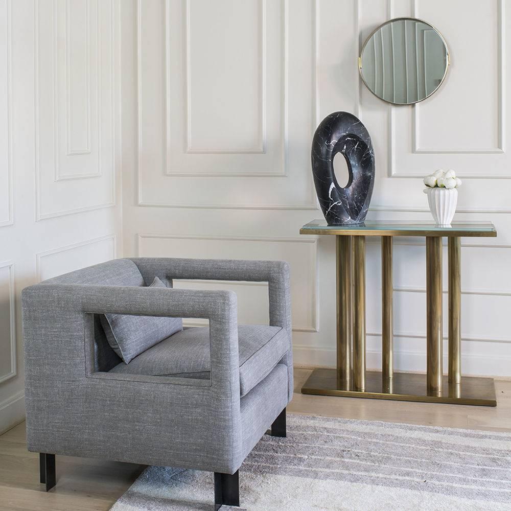 Drawing upon Kelly’s love of sculpture and metal, the Alta Mirror is composed of a single 1/4 inch brass sheet finished in burnished bronze patina and formed around an inset clear glass mirror. The design features a subtle overlap shape, adding