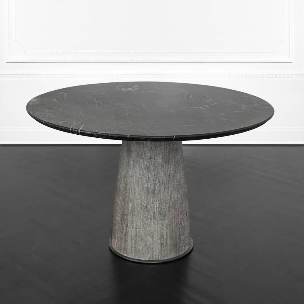 Composed of a solid wire brushed cerused wenge base with a brass foot and collar in burnished bronze patina, the Camden table joins Kelly’s affinity for raw, organic materiality and Classic silhouettes. The top is a reversed beveled edge of honed