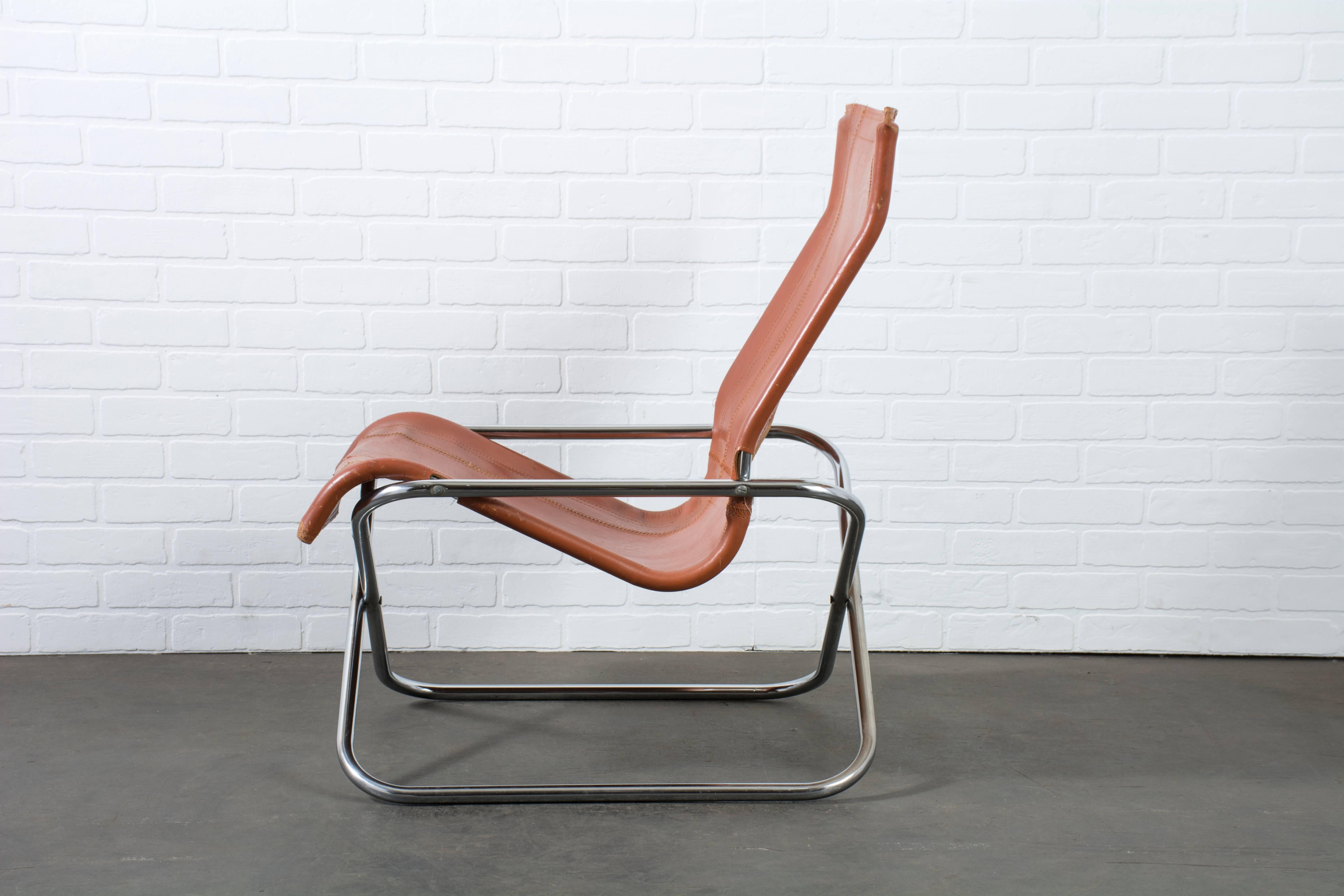 This is a Mid-Century Modern folding lounge chair by Uchida, circa 1970s, Japan. It features a chrome-plated steel frame and the original leather seat.