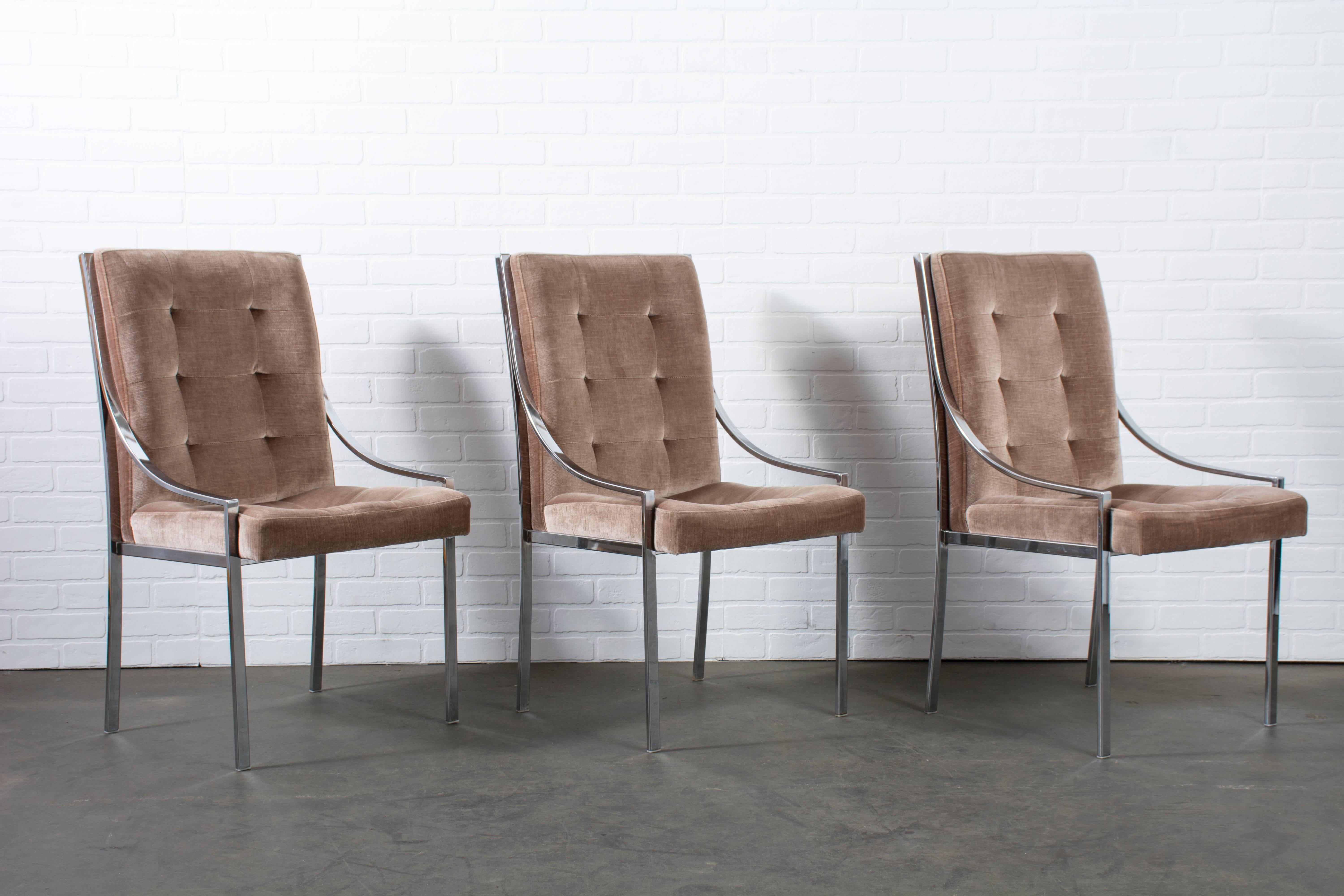 This is a set of six vintage dining chairs by Pierre Cardin, circa 1970s. They feature chrome-plated metal frames and the original brown tufted upholstery. This is a great set to reupholster in the fabric of your choice.
 