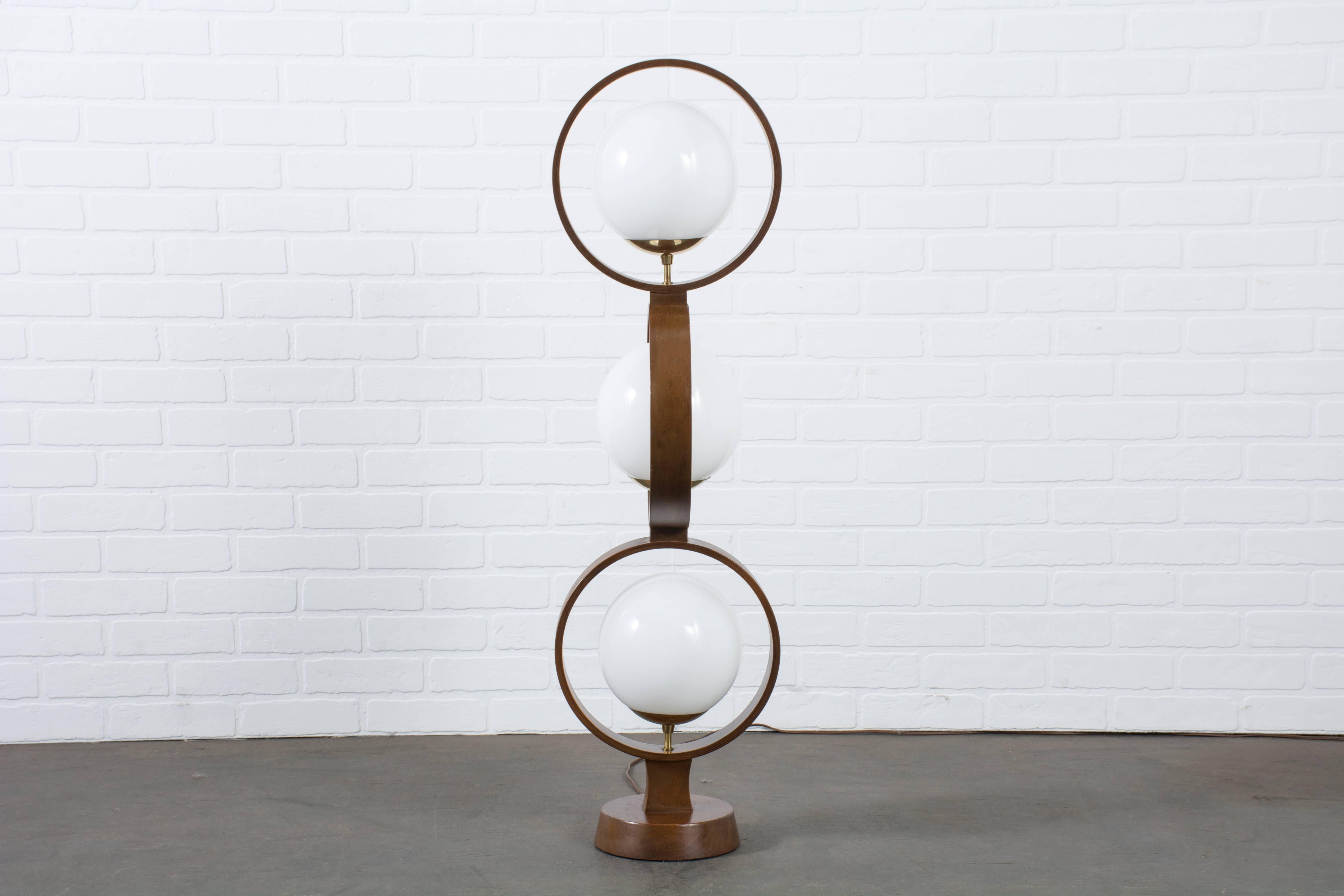 This Mid-Century Modern three-globe floor lamp is by Modeline, circa 1960s. Switch is on the base.

Measurements:
42