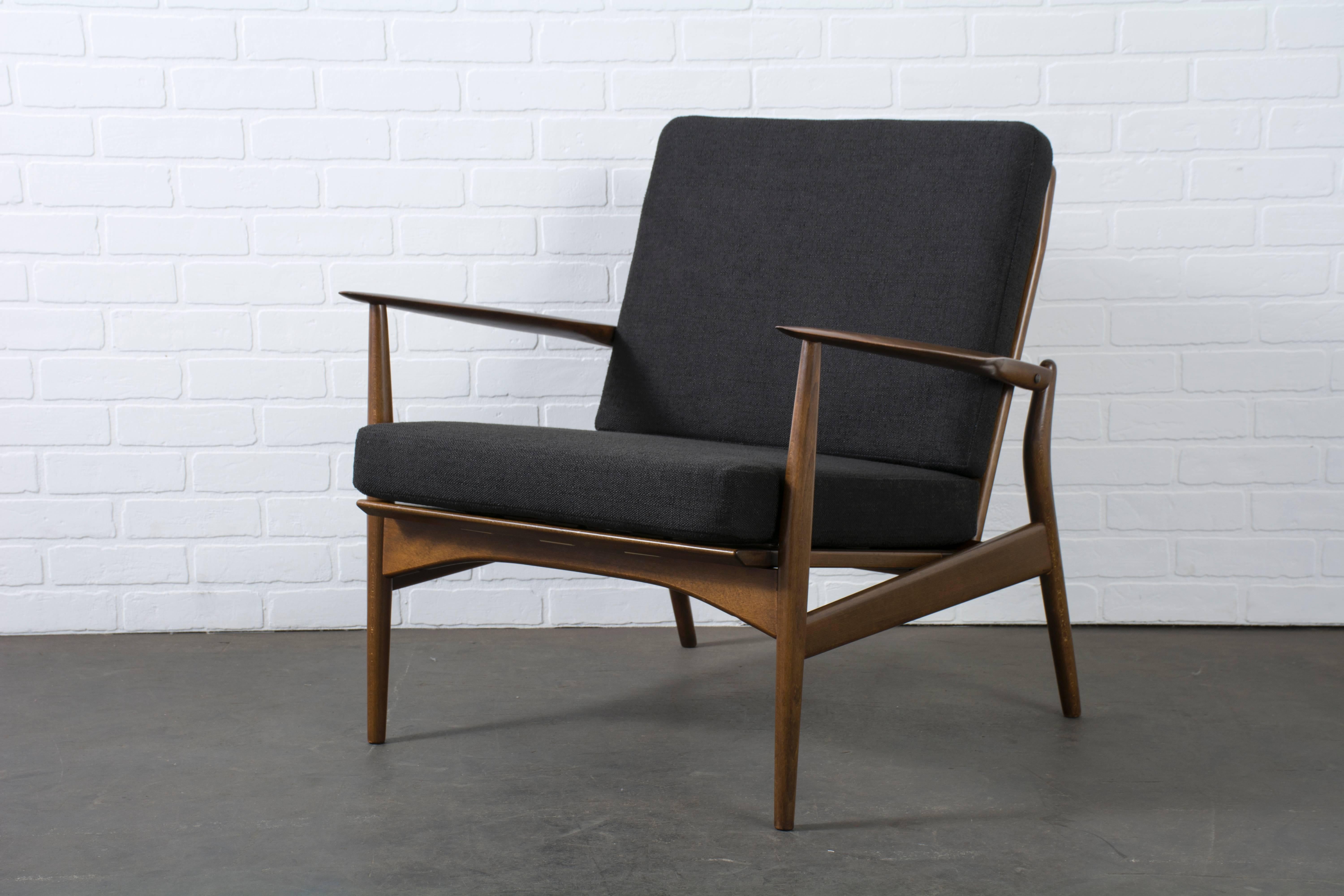 This vintage Mid-Century 'Spear' chair was designed by Ib Kofod-Larsen for Selig (Model #544-15) in the 1960s. It has a sculptural frame with a walnut finish and cane back. New black upholstered cushions.