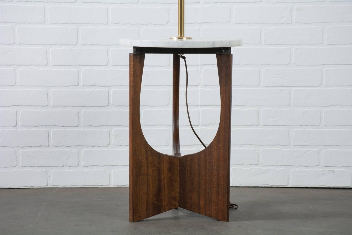 This is a Mid-Century Modern floor lamp with a walnut base, marble tabletop and brass stem. Marble tabletop marked Italy.
    