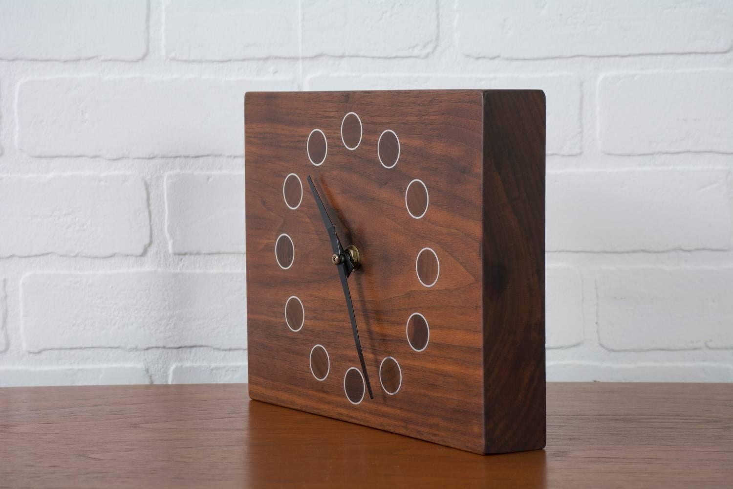This Mid-Century Modern solid walnut clock can be used as a table/desk clock or as a wall clock.