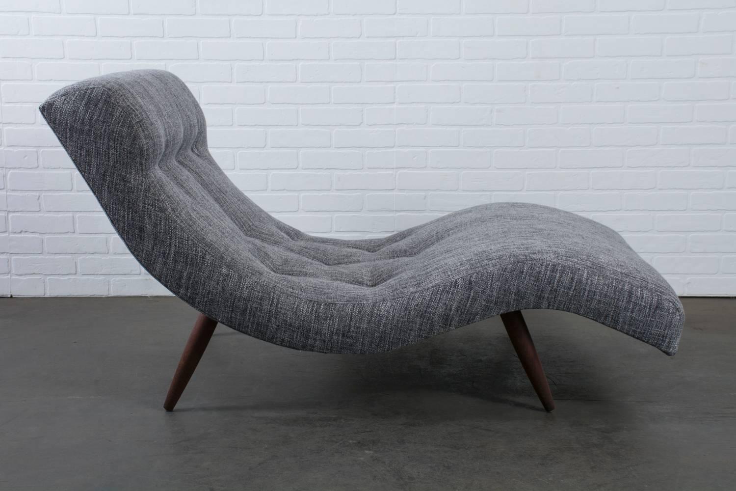 This Mid-Century Modern chaise longue was designed by Adrian Pearsall for Craft Associates in the 1960s. This piece has been reupholstered in a grey textured fabric. The wave shape and thicker foam on the head rest give this chaise great lines and