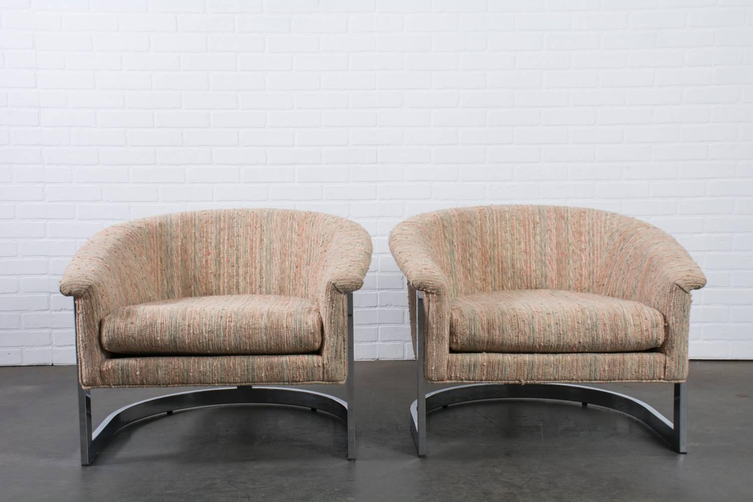 These Mid-Century Modern lounge chairs have sturdy barrel back frames and the original vintage upholstery. Any fabric you choose to reupholster this pair in will stand out beautifully against the round chrome frames. Marked Made in Italy, circa