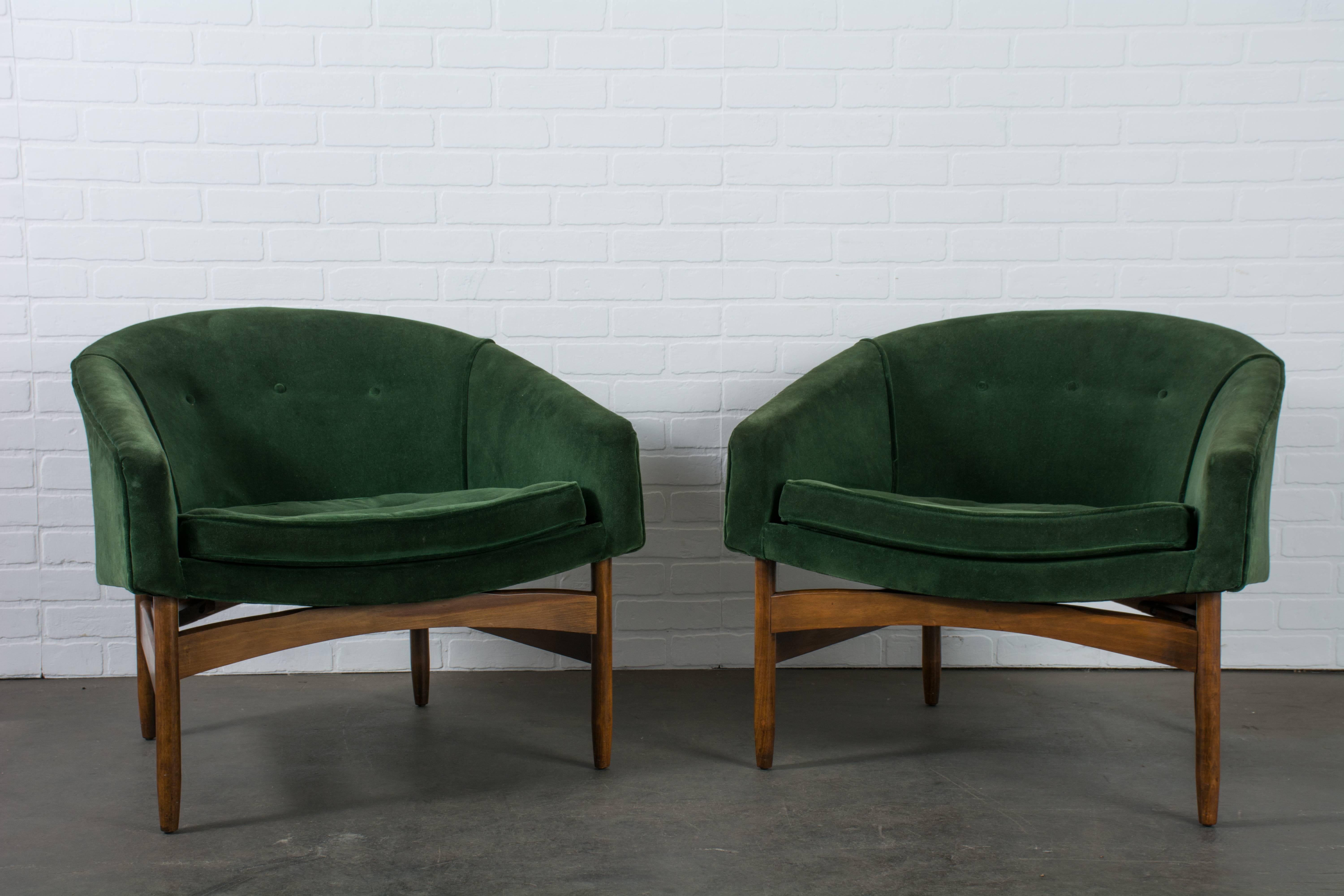 This pair of vintage Mid-Century barrel back lounge chairs were designed by Lawrence Peabody for Richardson Nemschoff in 1958. They feature walnut frames and forest green upholstered seats. Original upholstery, but the straps and seat cushions are