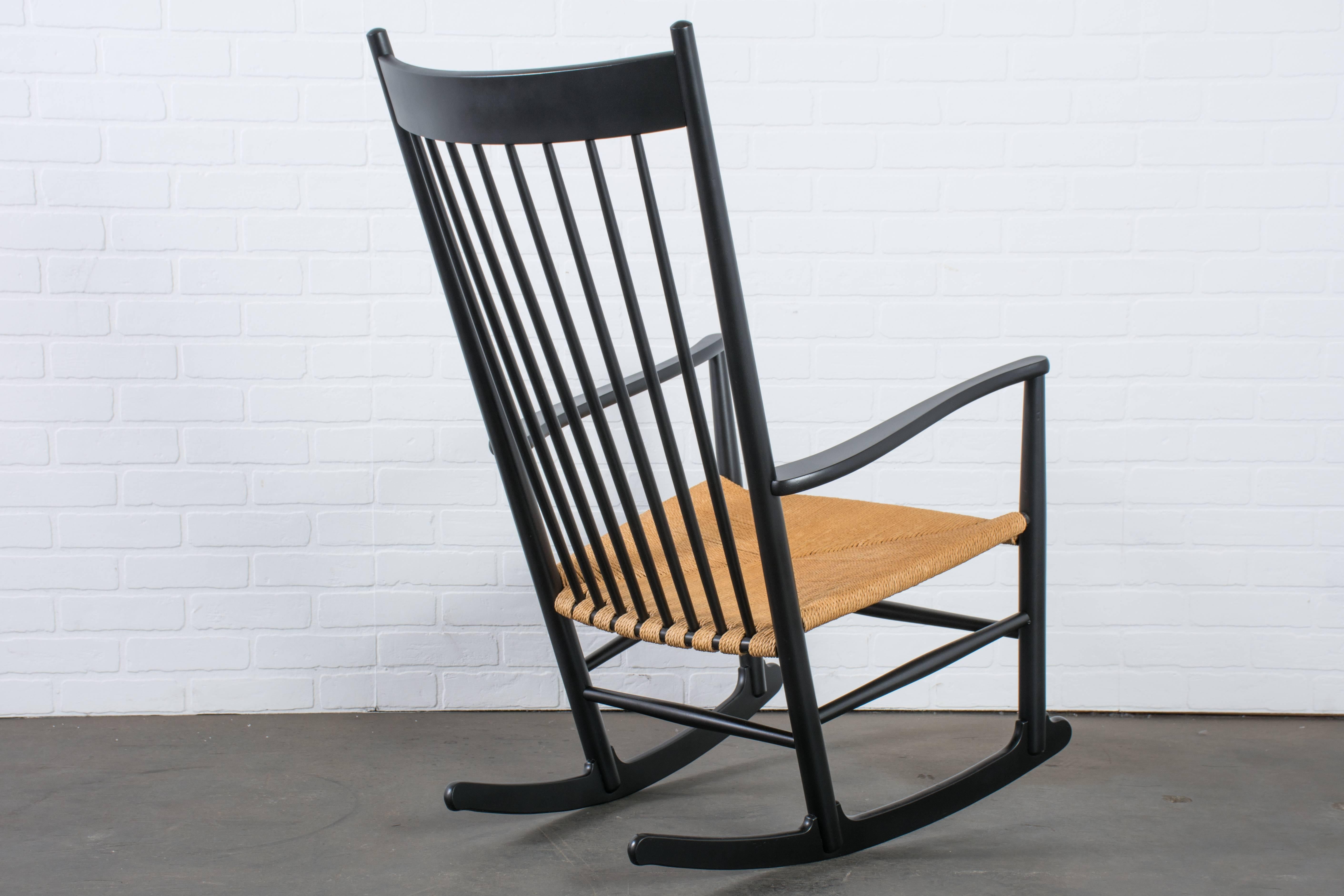 This Classic Danish Modern rocker was designed by Hans Wegner in the 1940s. It was first manufactured by FDB Mobler in 1944 and because of it's popularity, has been in production ever since. This vintage high back rocking chair has a beech frame