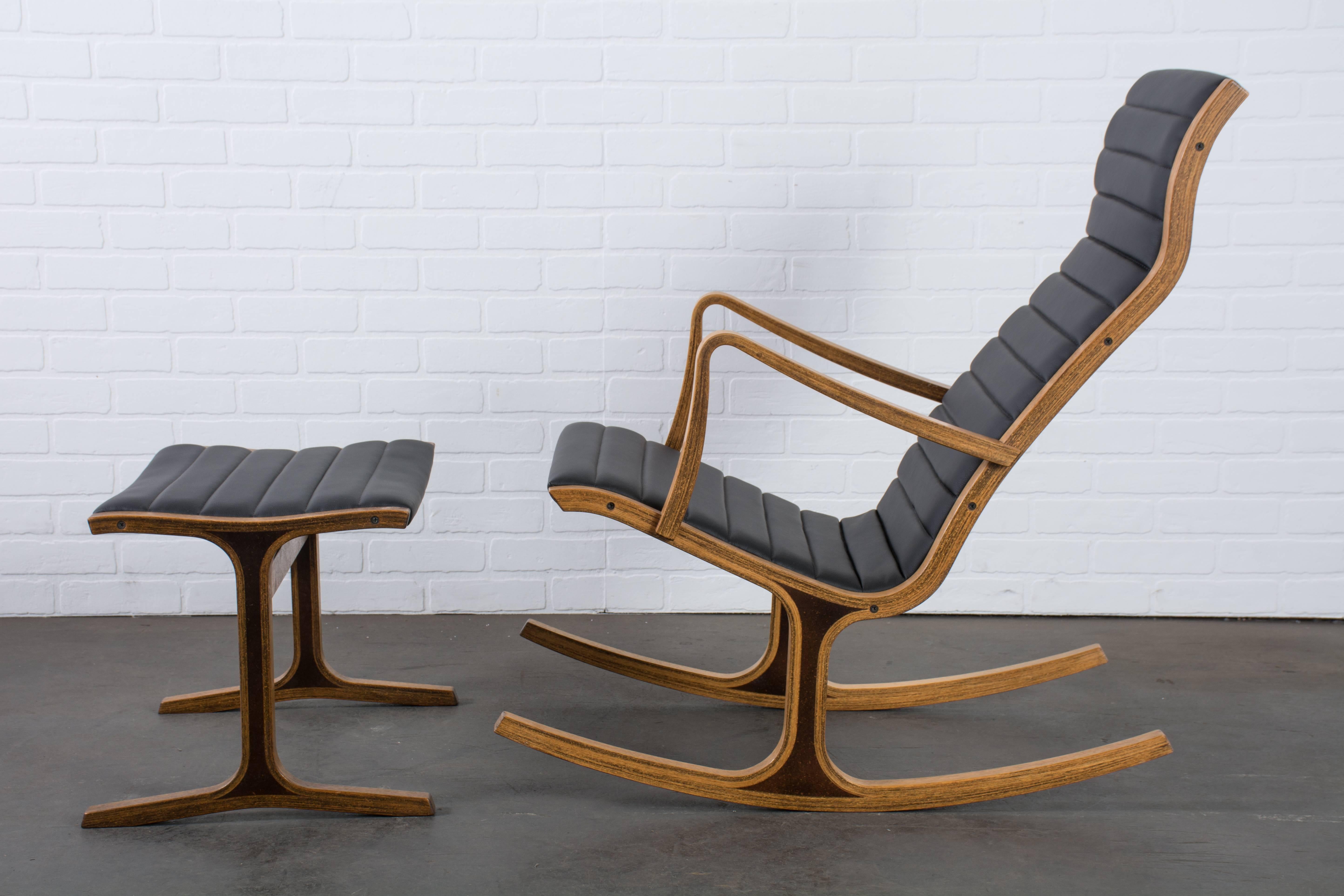 The award-winning Heron rocker was designed by Mitsumasa Sugasawa for Tendo Mokko, Japan in the 1960's. This vintage high back rocking chair comes with a footrest and features a bentwood frame in Japanese oak and professionally reupholstered black